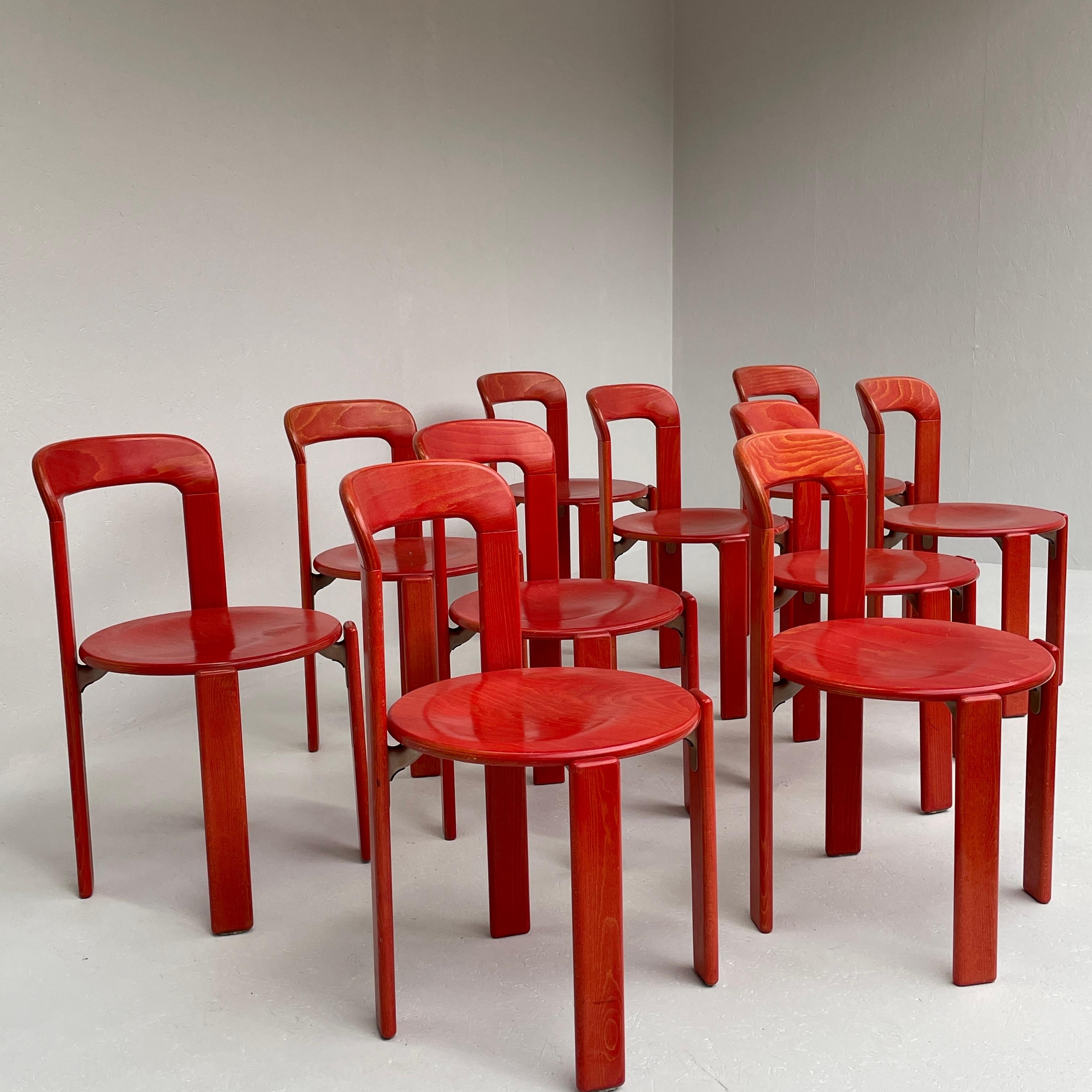 Rare and beautiful vintage stacking chairs by Bruno Rey for Dietiker.

The chairs are in an original virbant red color. Probably from the 1990.

Solid and very sturdy construction with Dietiker’s unqiue screwless wood-to-metal design.

The set