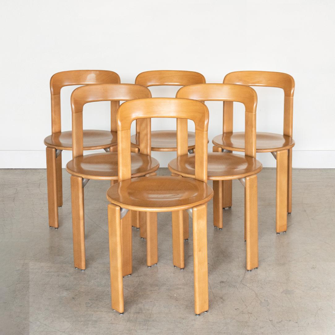 Fantastic set of 6 stackable vintage dining chairs designed by Bruno Rey, Switzerland, circa 1970's. Made of beechwood, laminated beech plywood and cast aluminum with original finish. Great vintage condition with minor signs of age and use.