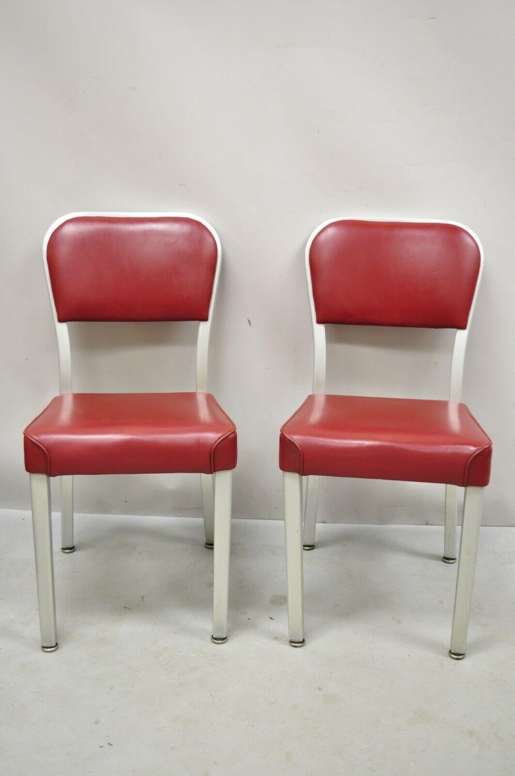 Vintage brushed aluminum red upholstered Emeco Navy Style side chairs - a pair. Item features brushed aluminum metal frames, red vinyl upholstery, marked 