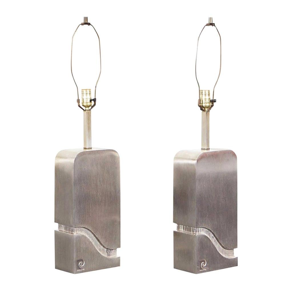 Stunning pair of vintage brushed steel lamps designed by Pierre Cardin for Laurel Lamp Company in the United States, circa 1970s. These lamps have a fascinating design, they have a rectangular body with elegant rounded edges. Through its structure,
