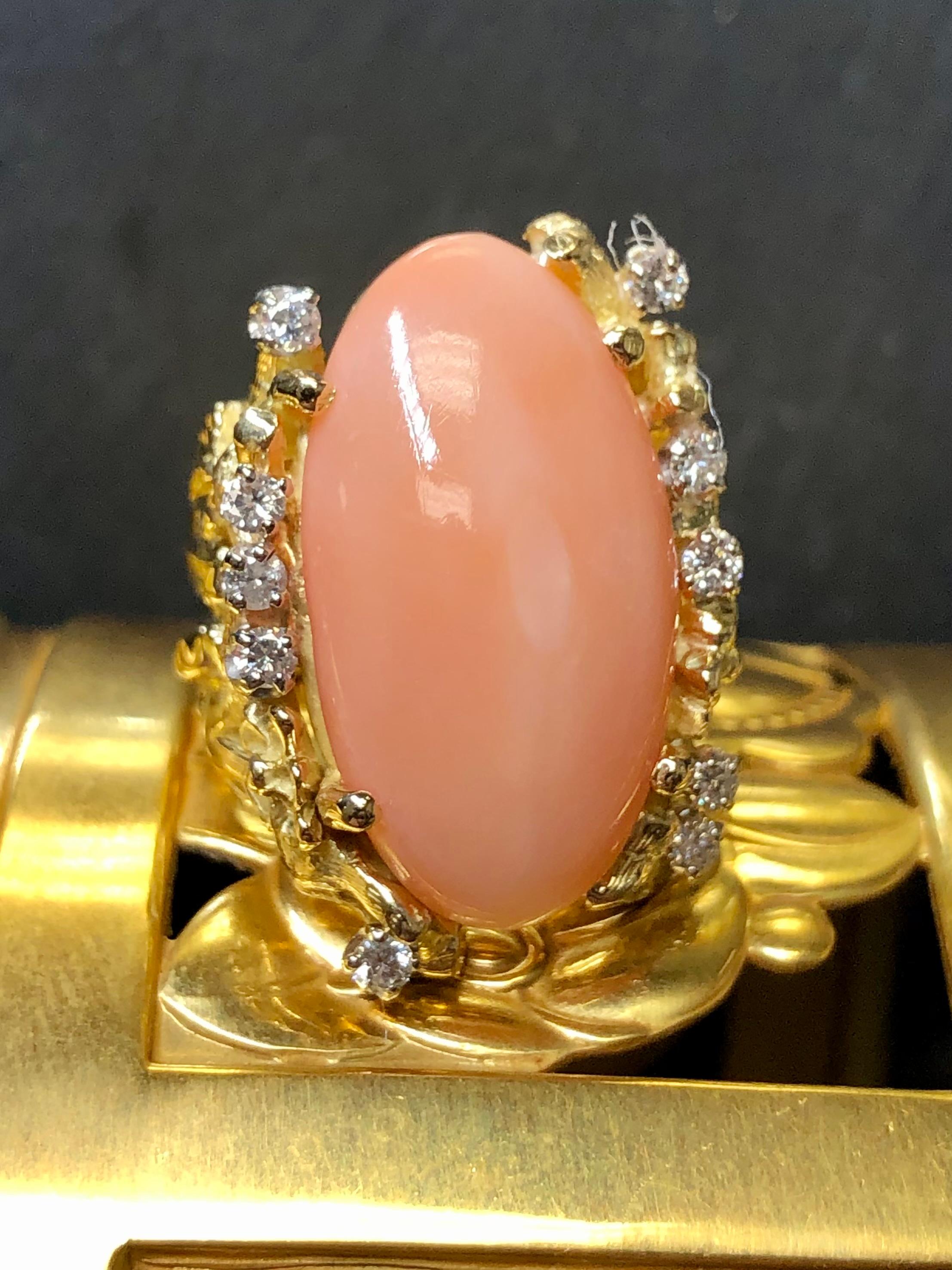 
A beautiful vintage ring done in the the brutalist style, hand wrought in 18K yellow gold and centered by a natural coral cabochon flanked by approximately .30cttw in G-I color Vs1-2 clarity diamonds.


Dimensions/Weight:

Ring measures 1” by .75”