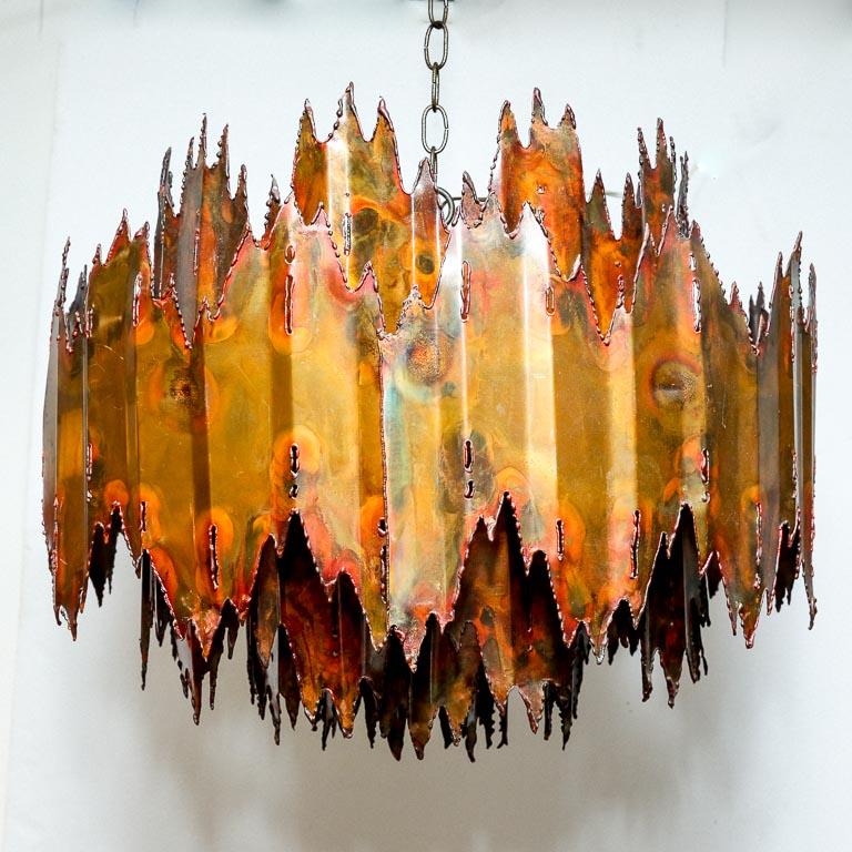Vintage chandelier by Tom Greene for Feldman. Constructed of multiple plasma cut brass shades. Does not include ceiling cap.

This lamp is currently set up for hard-wiring. We offer a service to add custom length cord and/or outlet plug for an
