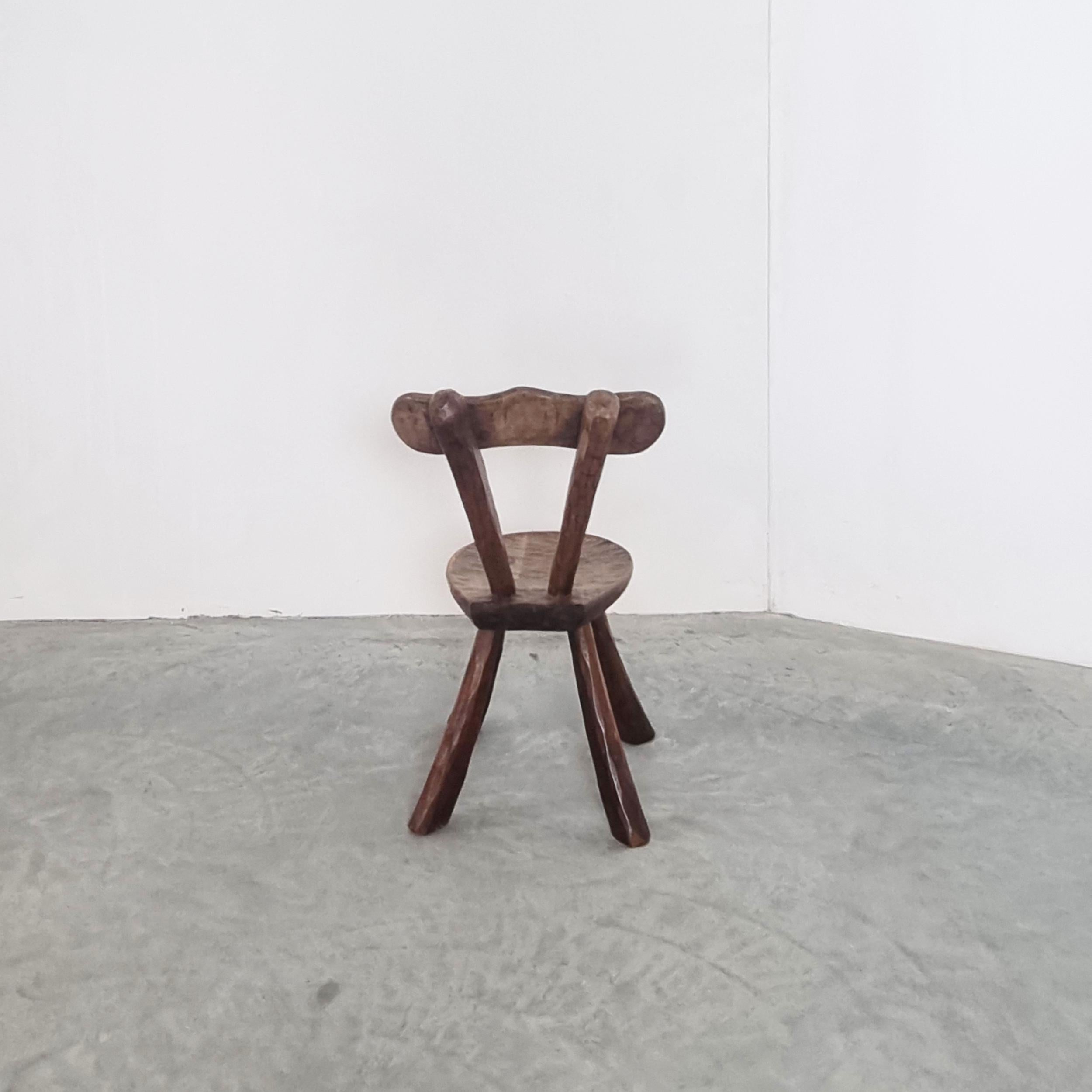A stunning small brutalist wood side chair crafted in the style of Alexandre Noll, exuding timeless elegance and character. This handcrafted piece, originating from France circa 1950, captures the essence of mid-century brutalist design with its