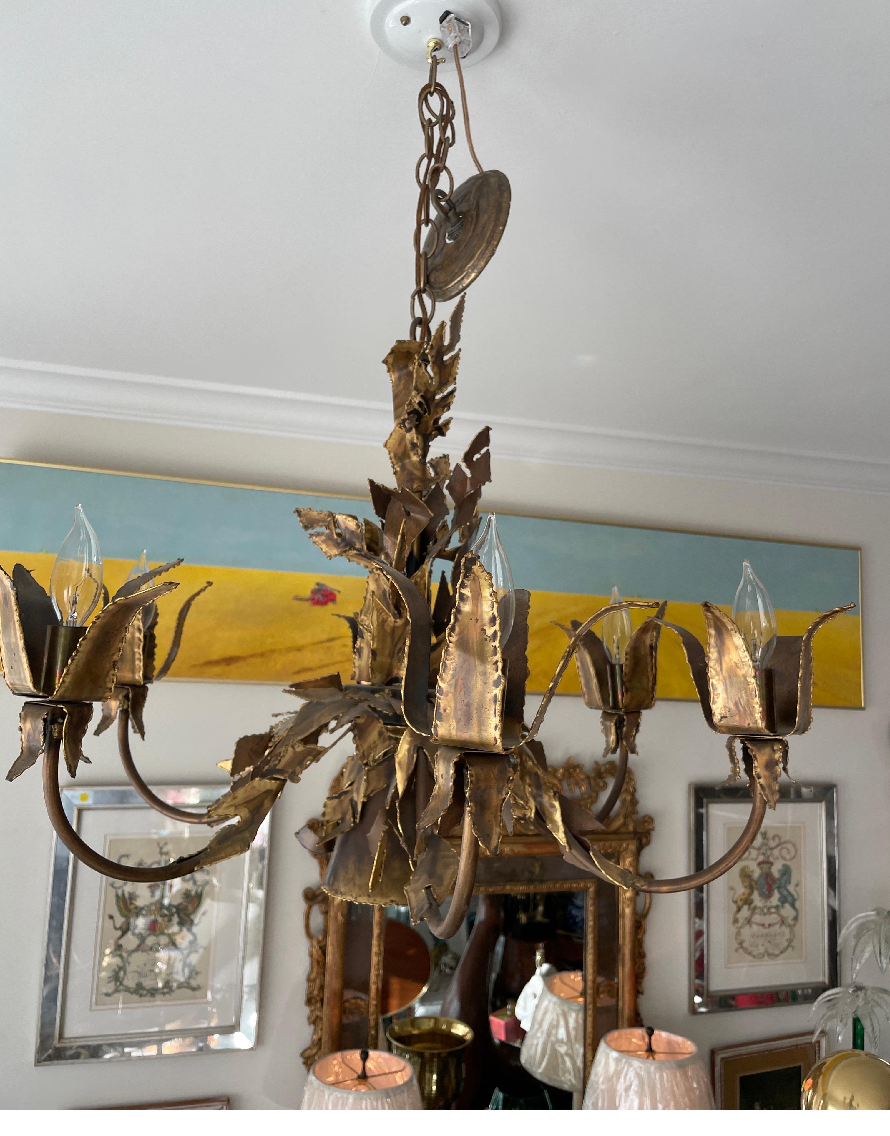 Vintage six arm Brutalist Chandelier by Tom Greene. Each arm ends with a tulip shaped flower encasing the light bulb. The central stem is wrapped in leaves. A very unique and unusual piece.