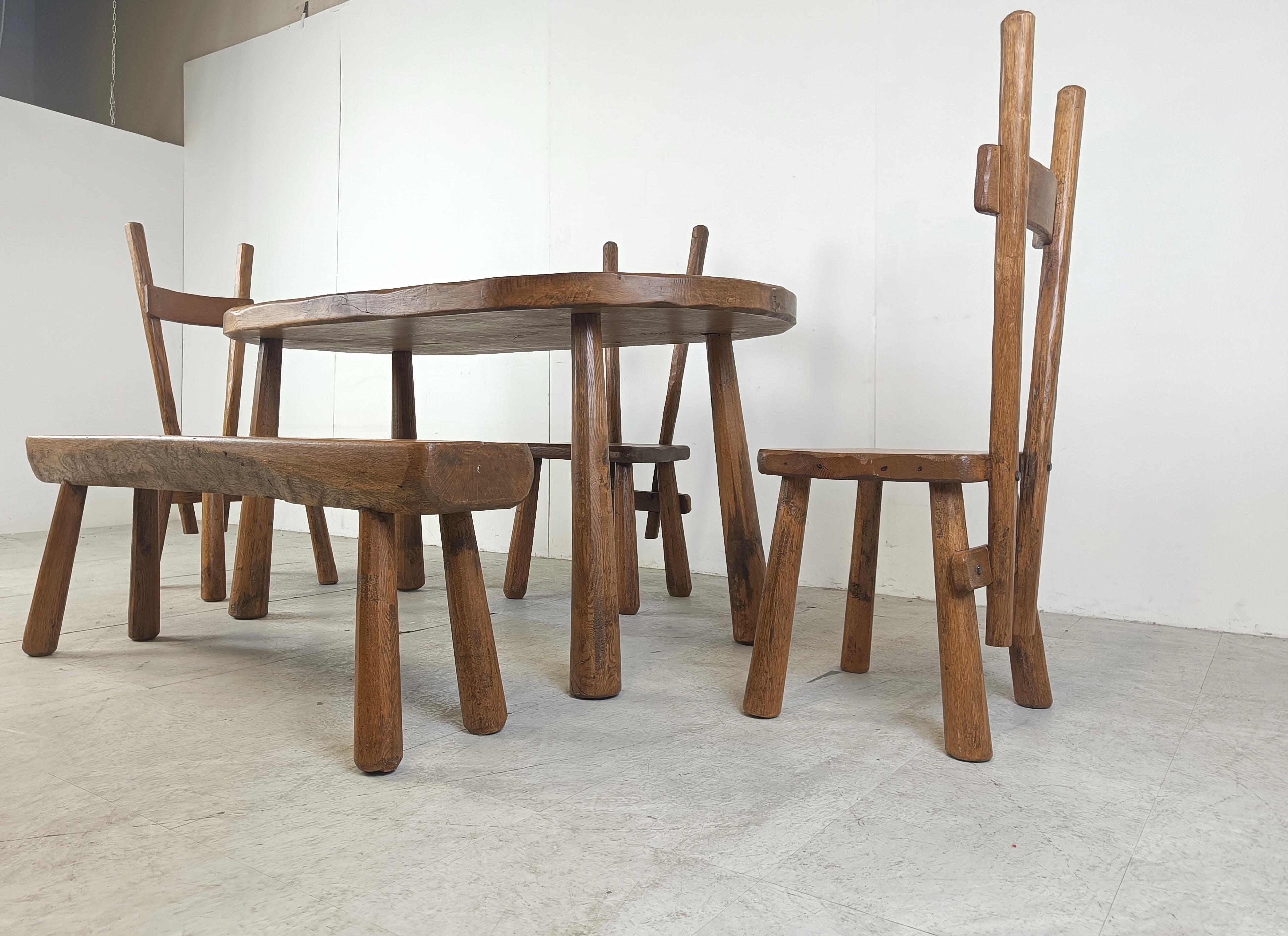 Sturdy and handcrafted dining set with a bench and three high back dining chairs.

This striking design and 'rough' hand made brutalist style is really standing out. 

The entire set is made out of solid oak.

Beautiful split backs with interlocking