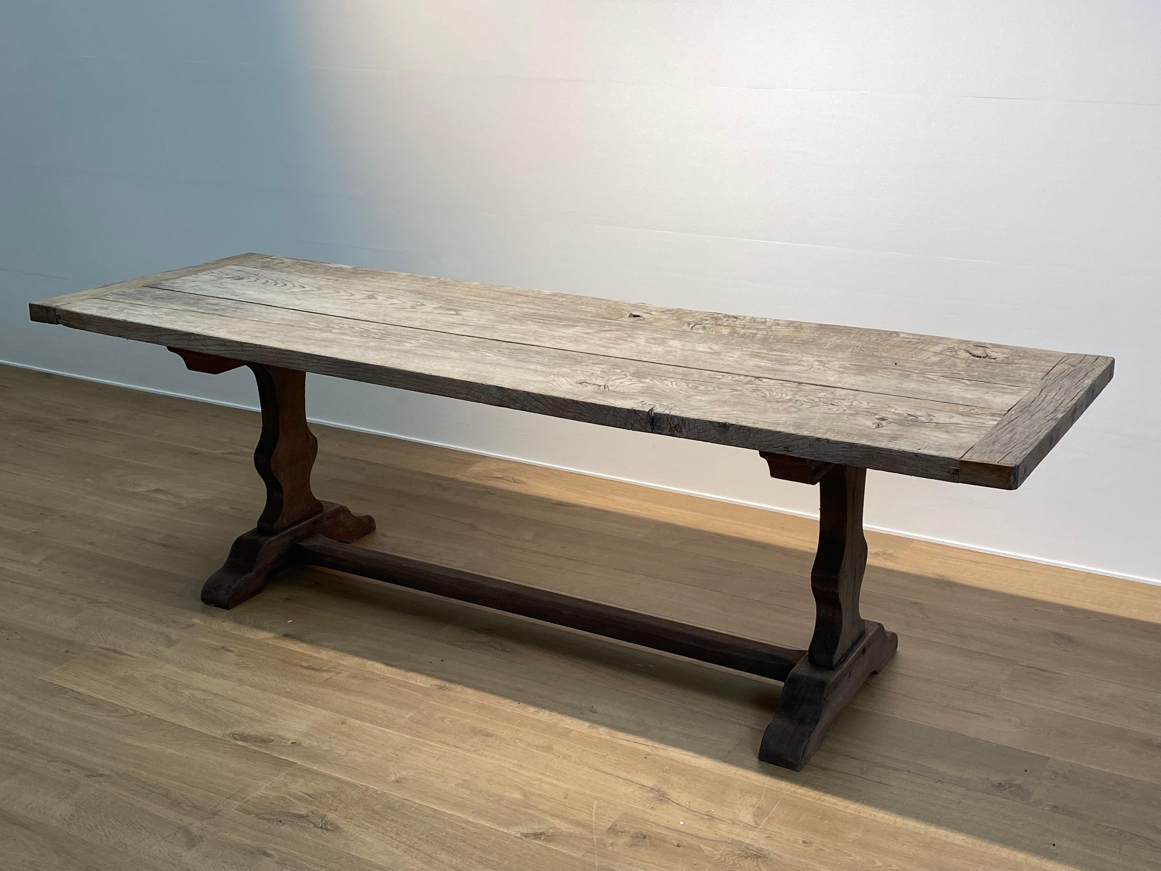Elegant French Farmers Table with an old Oak Table Top with 
a nice and warm bleached patina,
the base of the table ,two trestles, are made of Meranti wood,
very comfortable table to be used as a dining table or as a desk or 
as a console,
the table