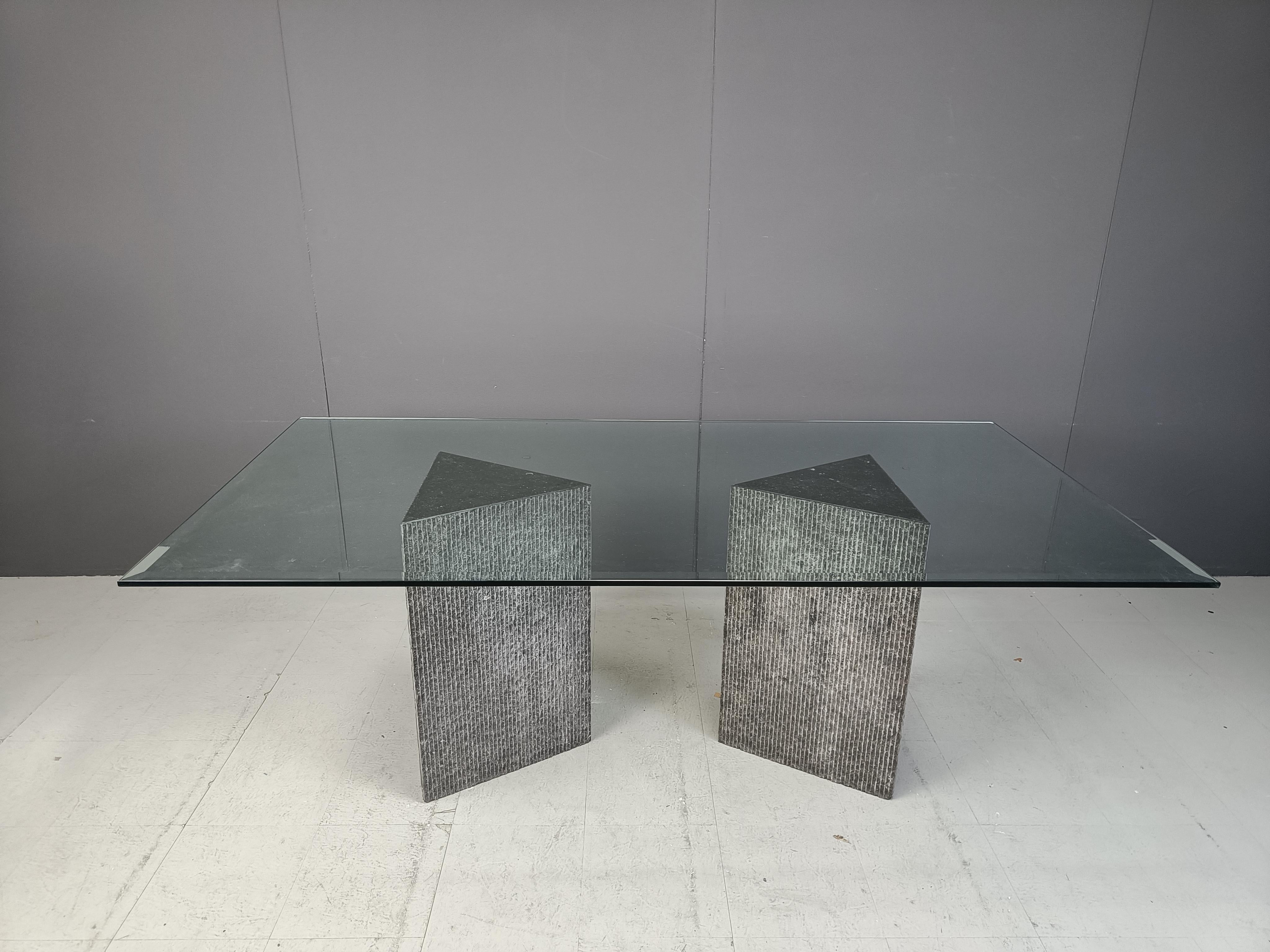 
Vintage dining table consisting of two black marble triangular reeded bases with a clear beveled glass top.

'Brut' and/or archictectural design - which remains timeless and thanks to the black colour, very easy to combine with a lot of
