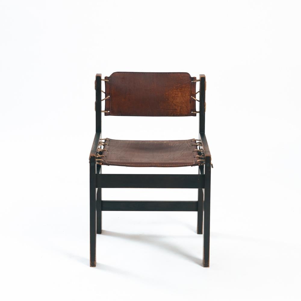 Beautiful and very rare set of 2 hideleather brutalist chairs from The Netherlands. Fully functional, all cleaned, waxed and leather nourished. On 2 of the chairs, the leather is torn. Can be fixed in a way that it doesn't effect the functionality.