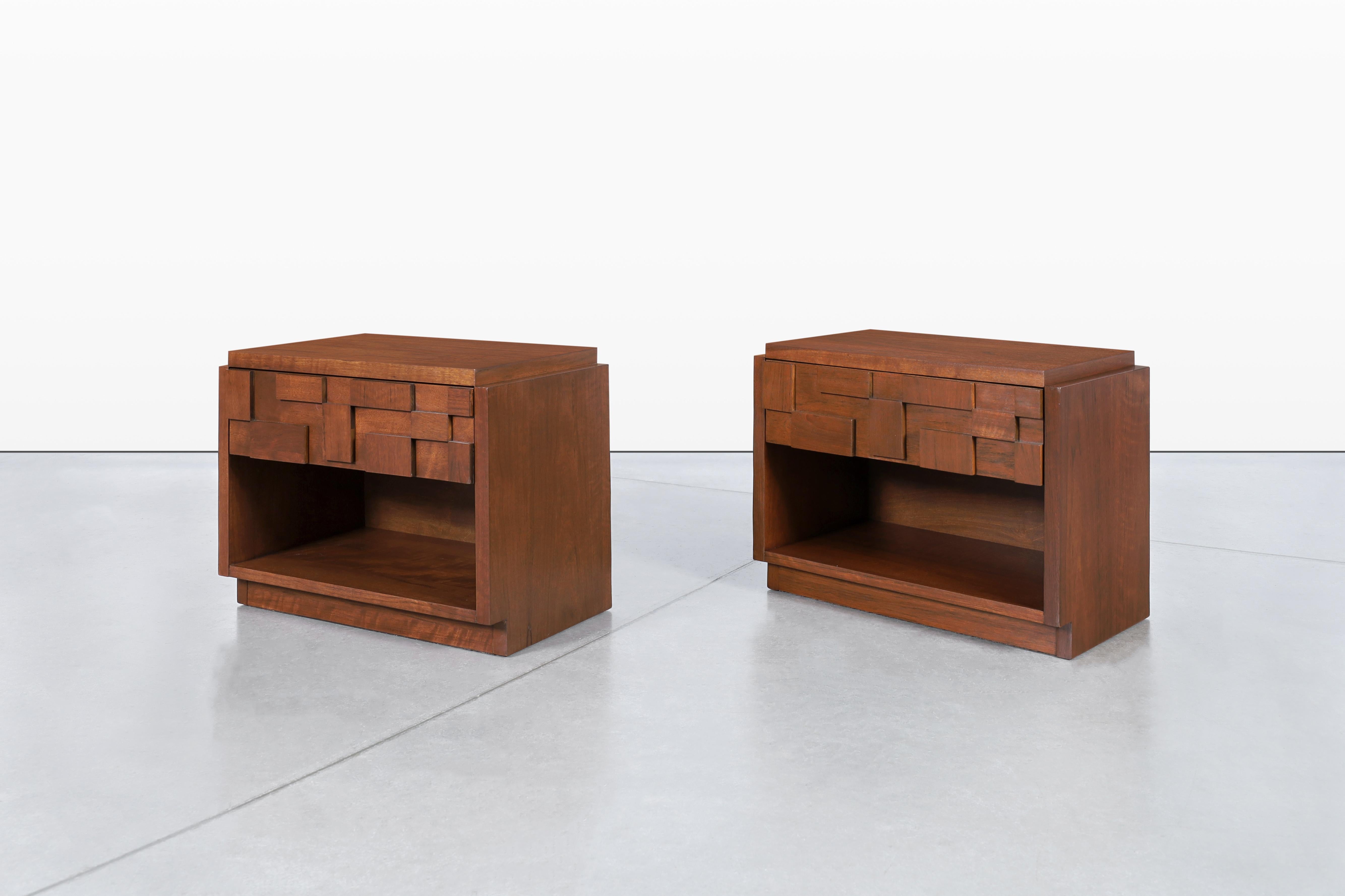 These exquisite walnut nightstands, designed in the 1950s by Lane Furniture as part of the iconic Staccato Collection, embody the blend of functionality and artistic design characteristic of mid-century modern furniture. Each nightstand showcases a