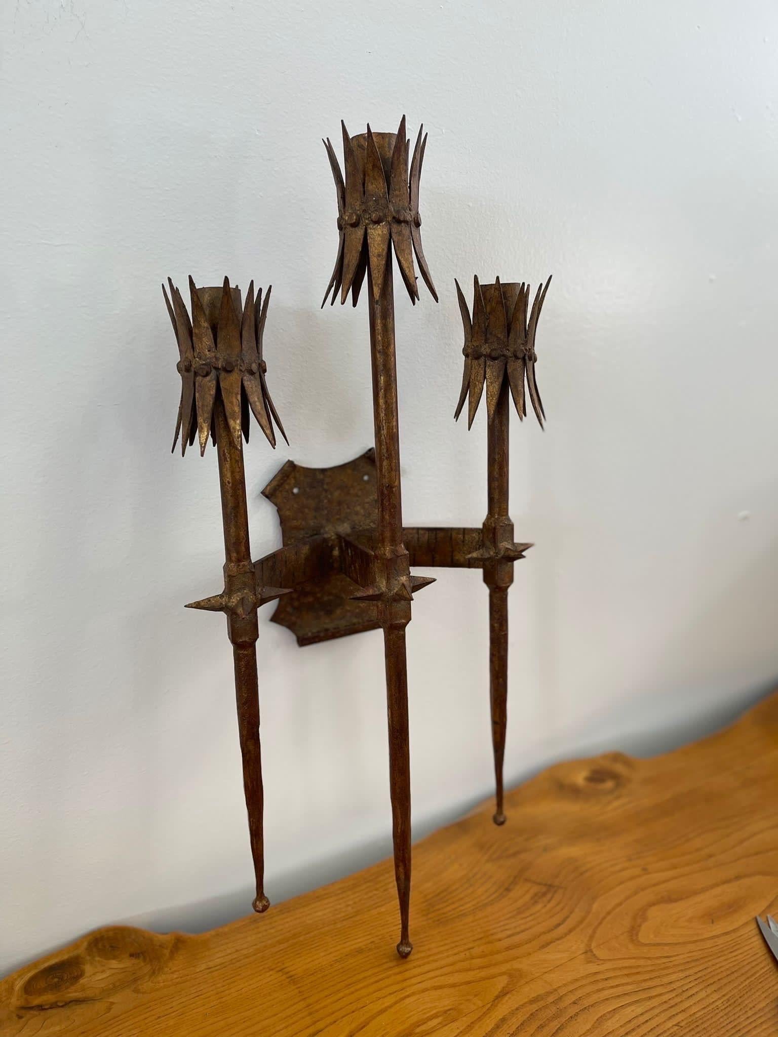 Three Pronged Wall Sconce . Possibly Spanish Based on Research. Spiked Poles That’s are pointed at the bottom. Back Plate has Holes to Place Screws Through.

Dimensions. 14 W ; 4 D ; 29 H