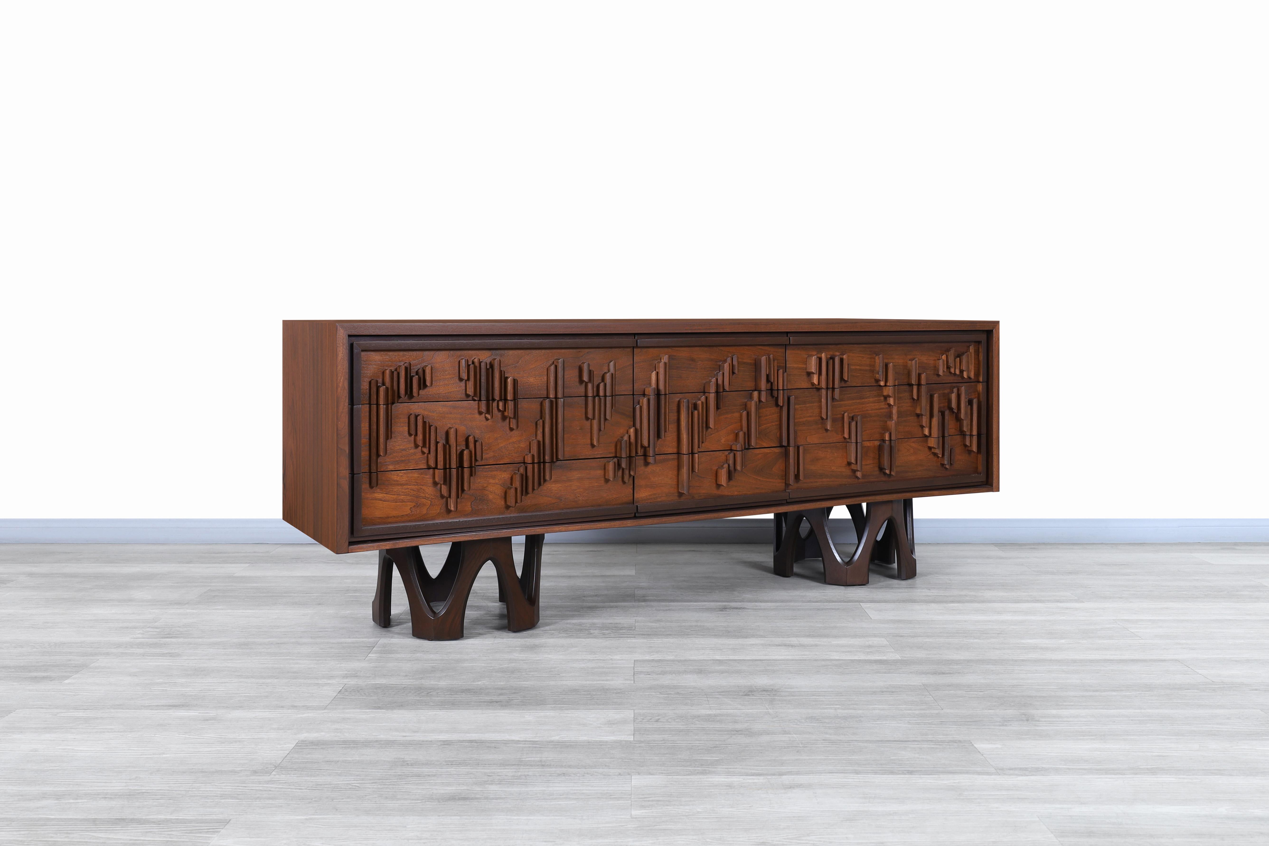 Stunning vintage Brutalist walnut credenza / dresser manufactured in Canada and custom made for Berman Bros., circa 1960s. This credenza has an avant-garde design where the quality of the walnut wood and the contrast of colors expressed throughout