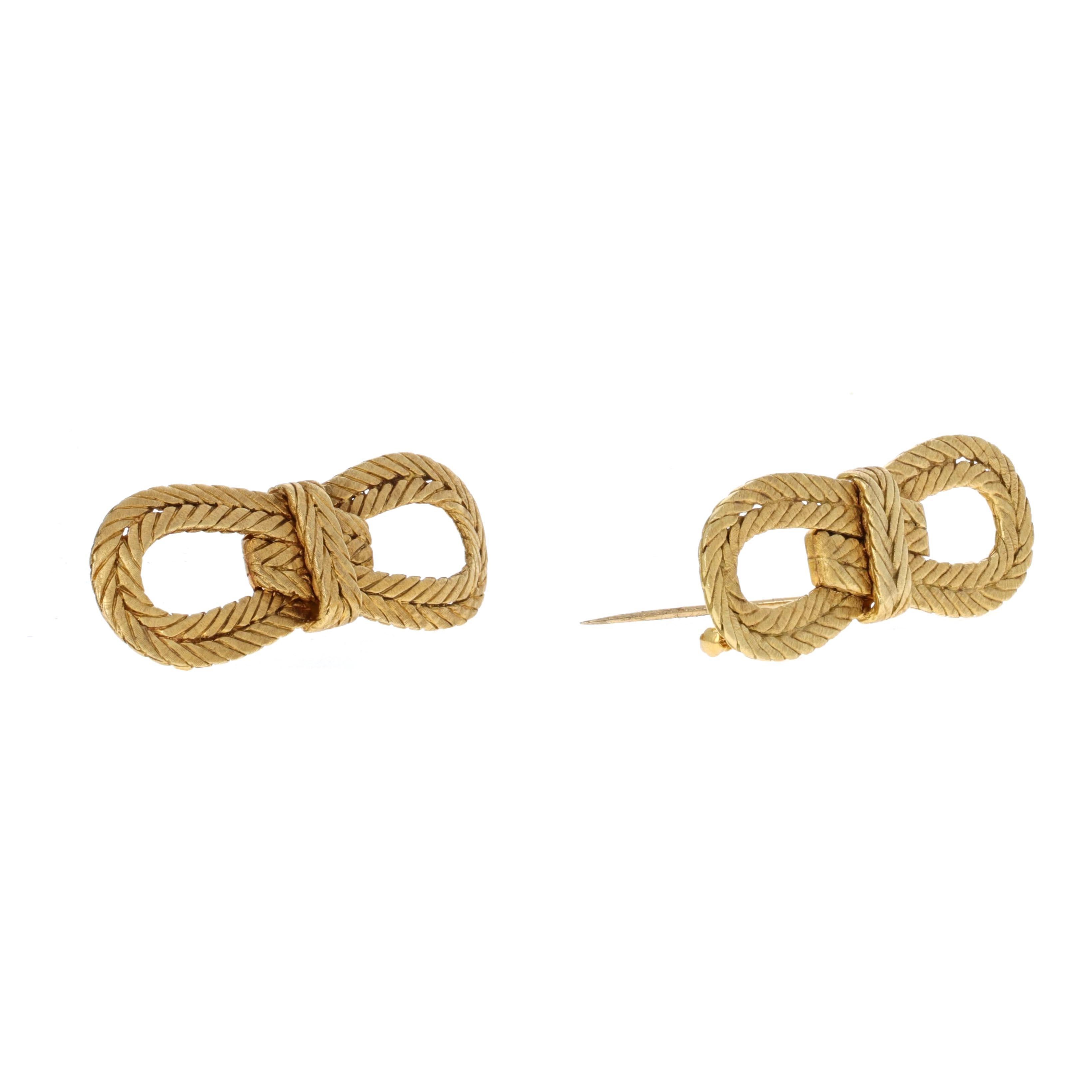 Vintage Buccellati, 18 karat yellow gold rope textured bow brooches. The two brooches are matching and sold as a set. The brooches are stamped Buccellati, Italy, 18 KT. They measure 53mm x 20mm and weigh 13.3 grams and 13.7 grams.

 They retailed