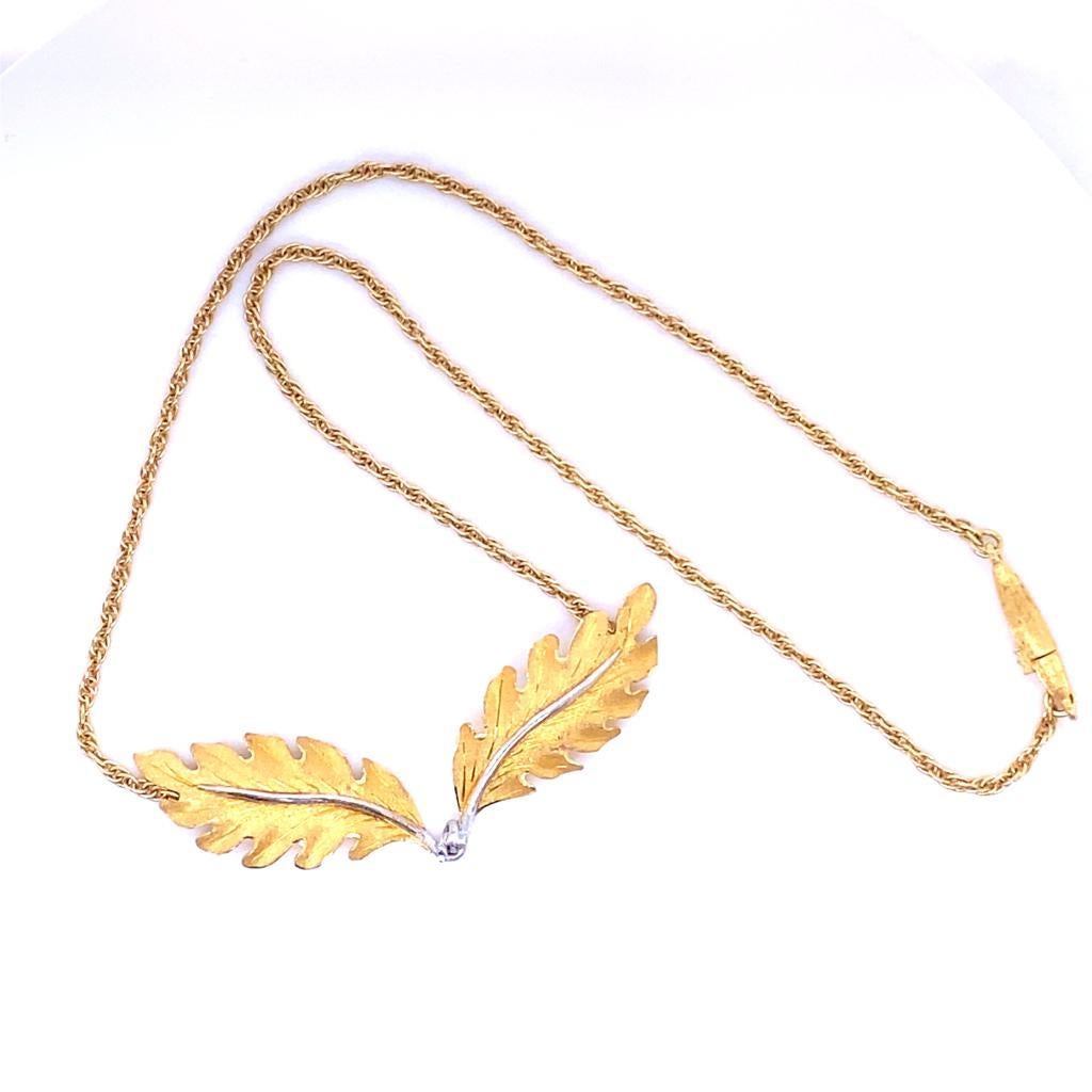 A vintage Buccellati 18 karat yellow and white gold leaf necklace, circa 1960.

snake chain 16 inches

Designed as a pair of yellow oak leaves joined at their white gold stalks, sitting on the collarbone of the wearer featuring Buccellati's