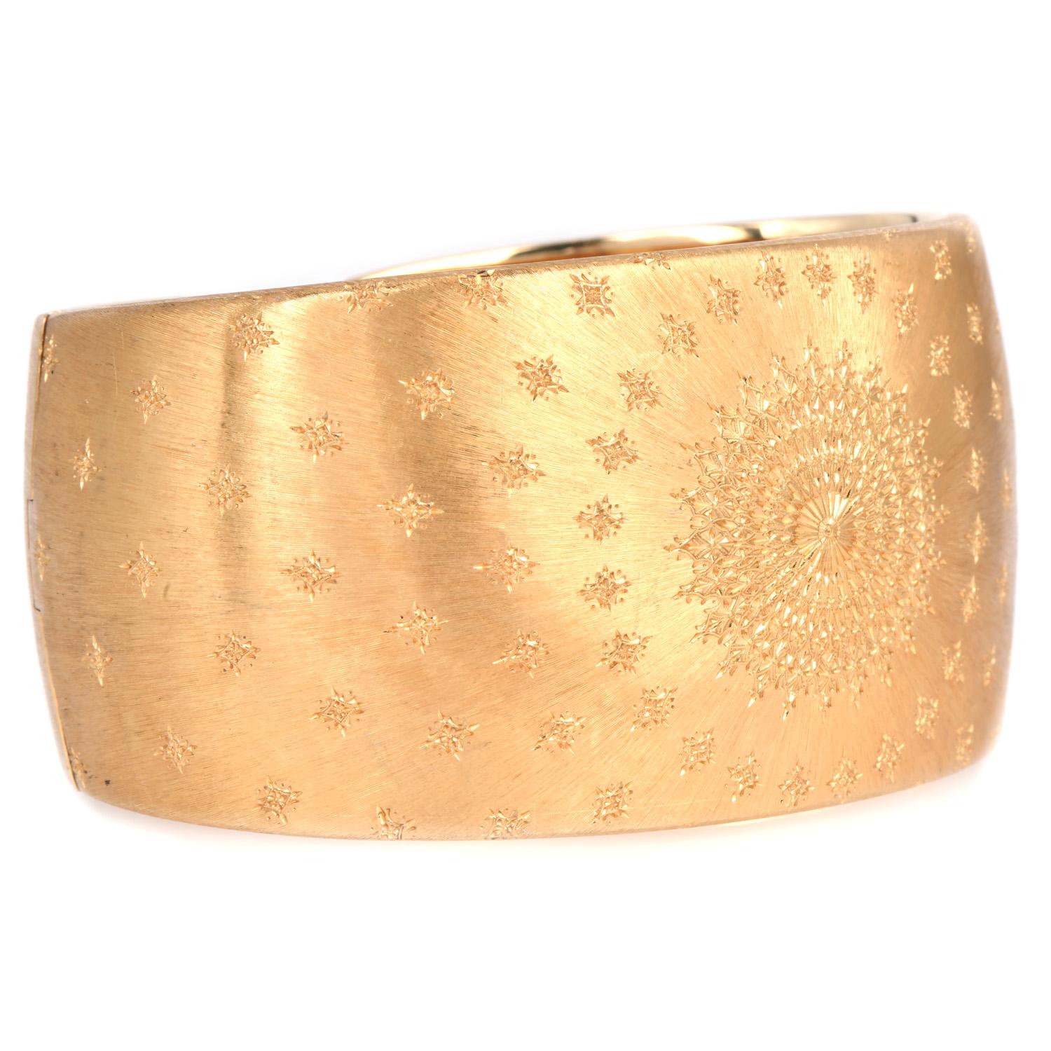 Presenting a gorgeous Buccellati Cuff bracelet in Solid 18k yellow gold.

An exquisite statement cuff bracelet, a testament to timeless elegance. Crafted from solid 18k yellow gold with a satin finish, this hinged cuff showcases intricate foliate