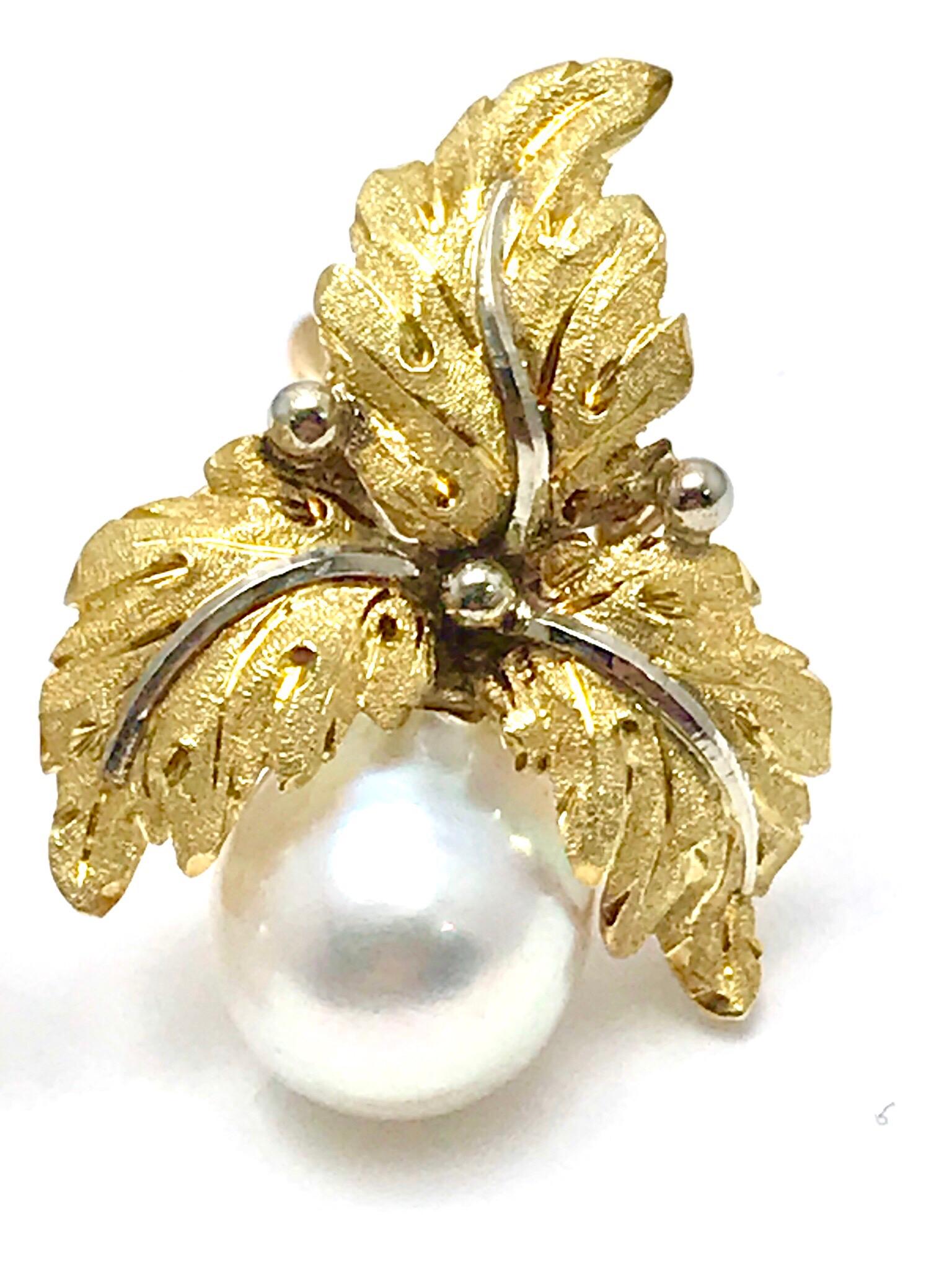 A beautiful pair of Buccellati 9.00mm Cultured Pearl and 18 karat white & yellow gold leaf clip earrings.  The leaves consist of brushed yellow gold foliage, with white gold stems, and the  pearl suspended from the three leaves.  They measure 1.00