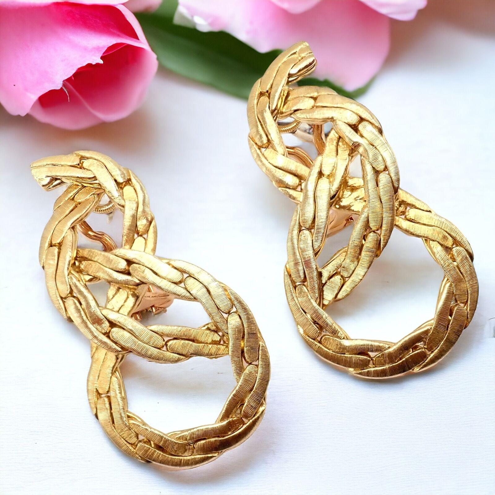 18k Yellow Gold Vintage Knot Rope Coil Drop Earrings by Buccellati.
These authentic vintage Buccellati earrings are a stunning representation of classic elegance and artisanal excellence. 
Crafted in 18k yellow gold, they feature a distinctive knot
