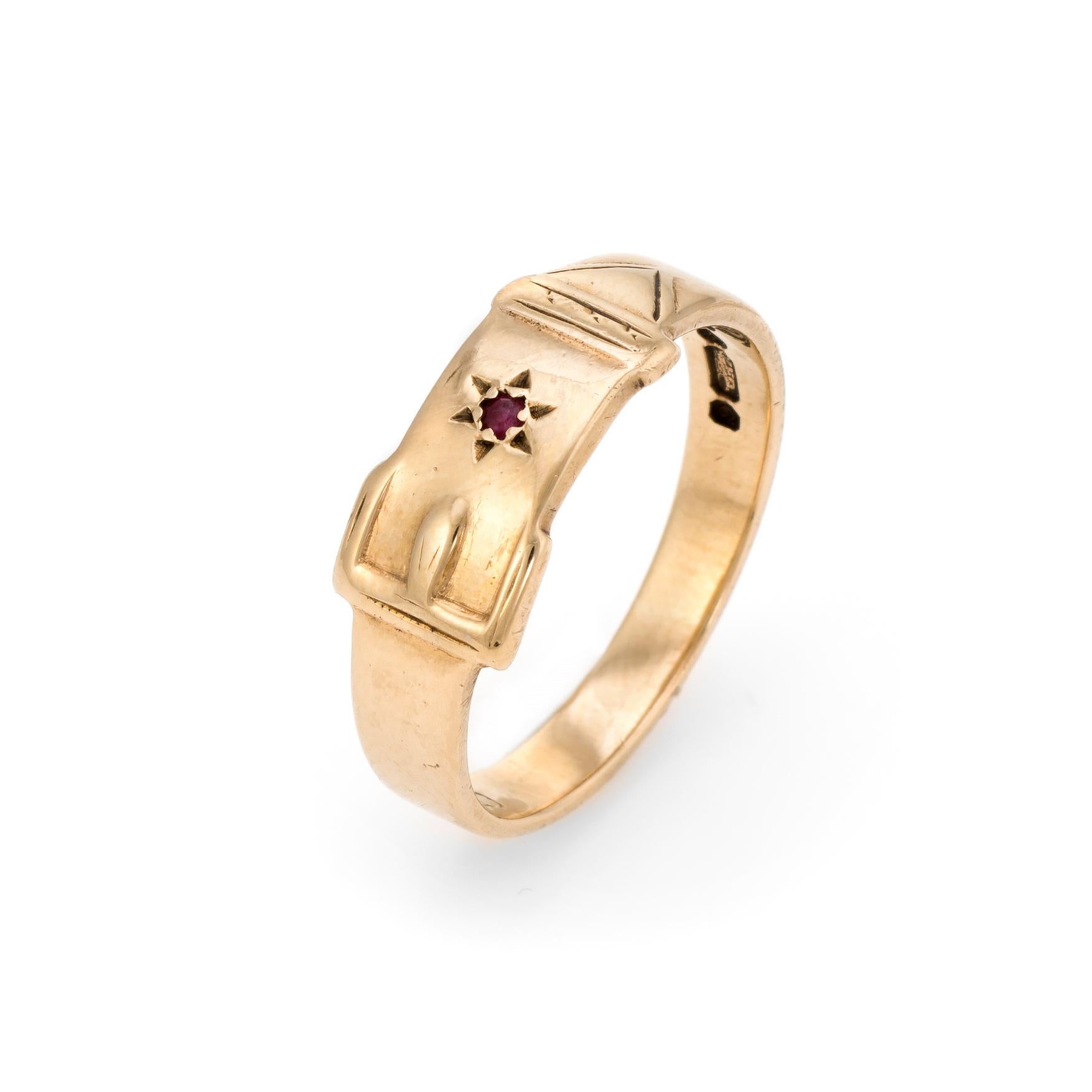Finely detailed vintage buckle band, crafted in 9 karat yellow gold. 

One estimated 0.01 carat ruby is set into the band.

The buckle design has long been popular as a promise ring or love token. The clasped belt wraps around the finger,