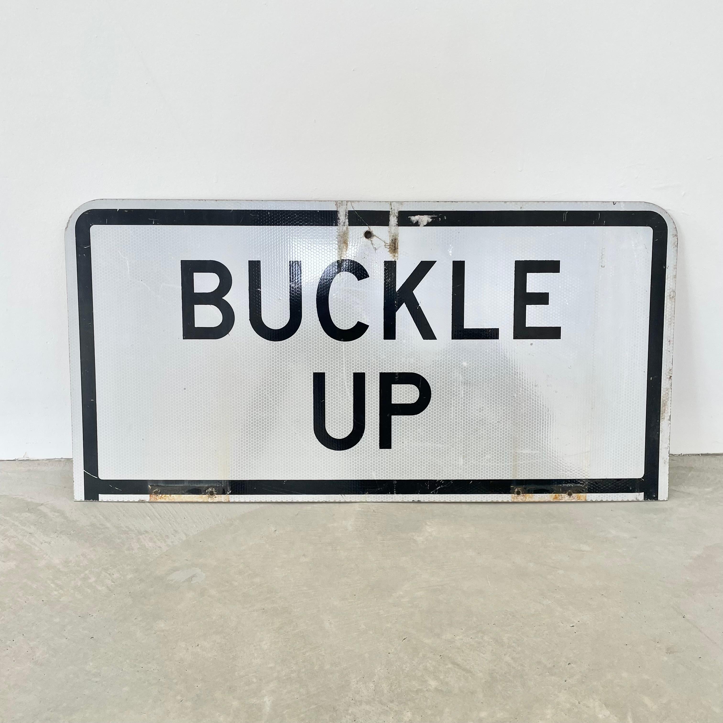 buckle up road sign