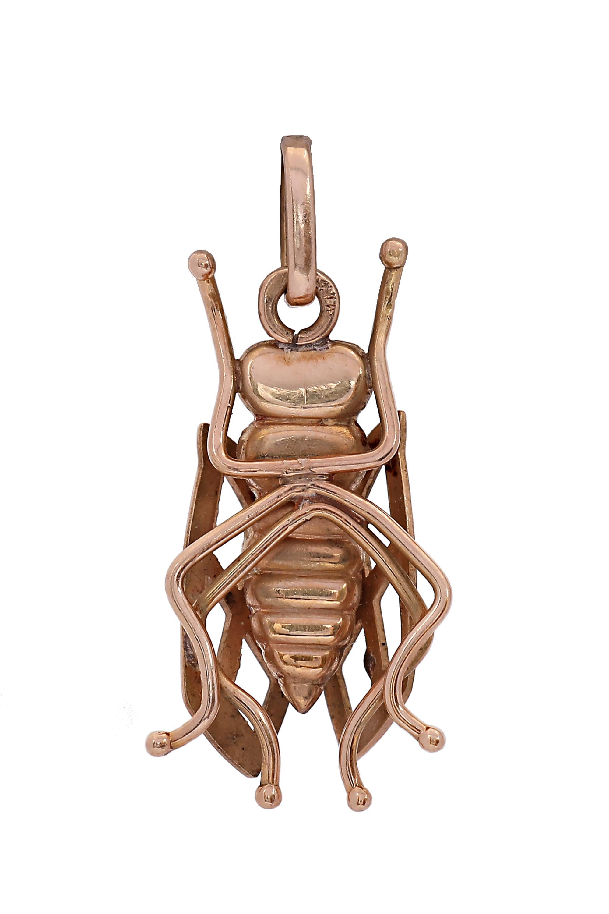 A stylized insect pendant crafted in 14K yellow gold. Unexpected and very striking! Measuring 0.5 inch wide and 0.75 inch long.