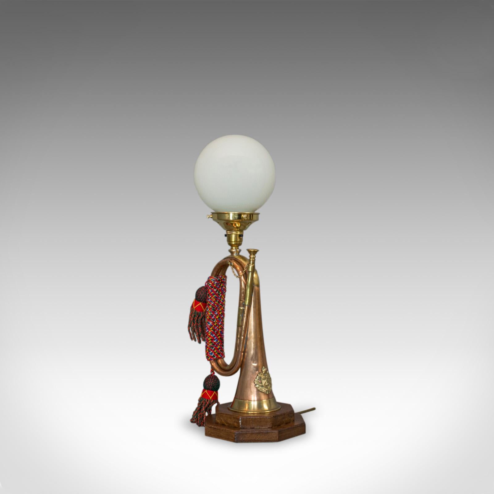 This is a vintage bugle lamp. An English, copper and oak military musical instrument, with a bespoke, handcrafted table light fitting and glass shade.

In excellent condition, fully working with quality, opaque pendant lamp shade
Bears the