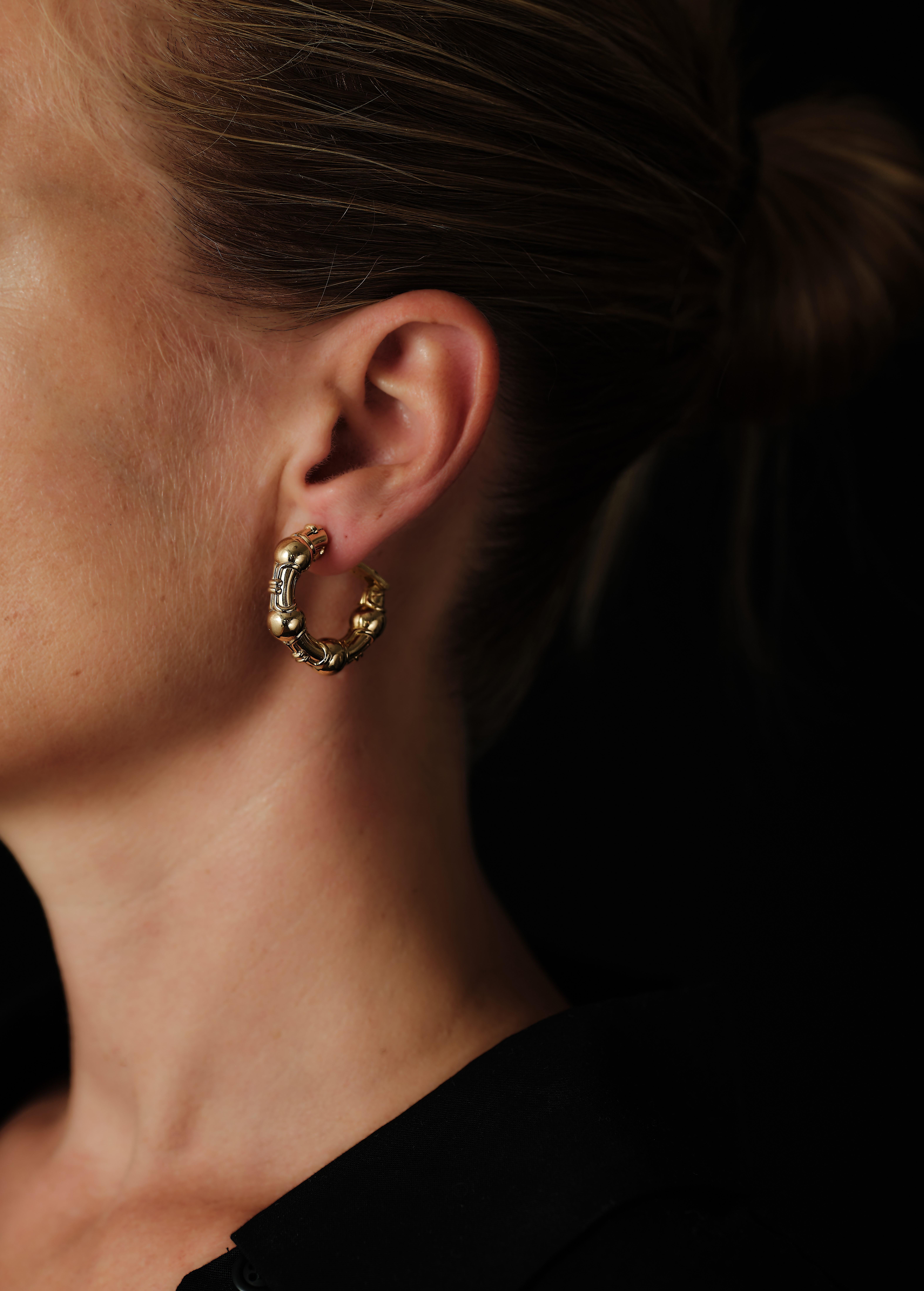 Vintage BVLGARI 18 karat gold hoop earrings made 1989. You know a pair of hoops are well made when they are purposely adjusted for left/right so that they display correct. 

Effortlessly cool as they are purposely elegant.
Italian hoopsvwith a