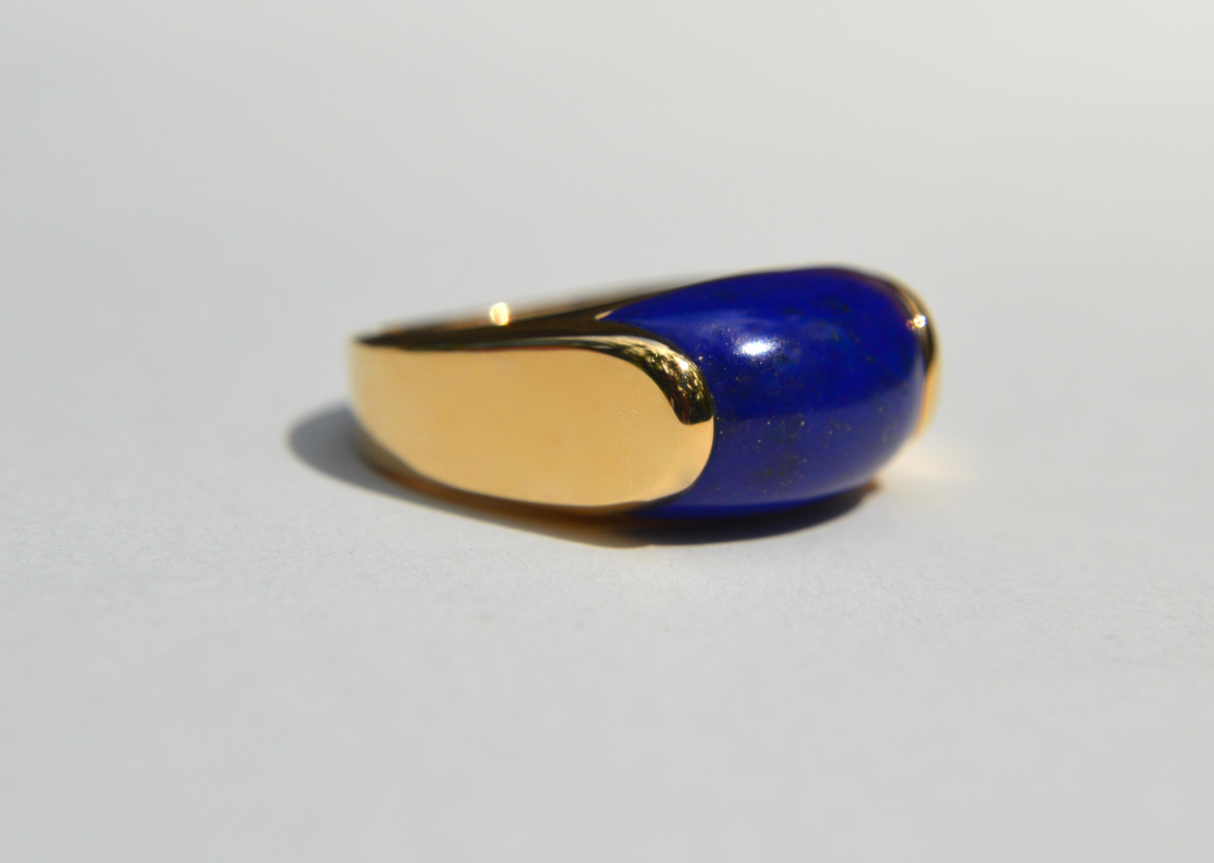 Gorgeous and very rare vintage c1990s Bulgari (Bvlgari) Italy Tronchetto ring in 18K yellow gold with a beautiful golden pyrite flecked lapis lazuli cabochon. In excellent pristine condition, appears unworn.  Size 5.5, resizing not recommended.
