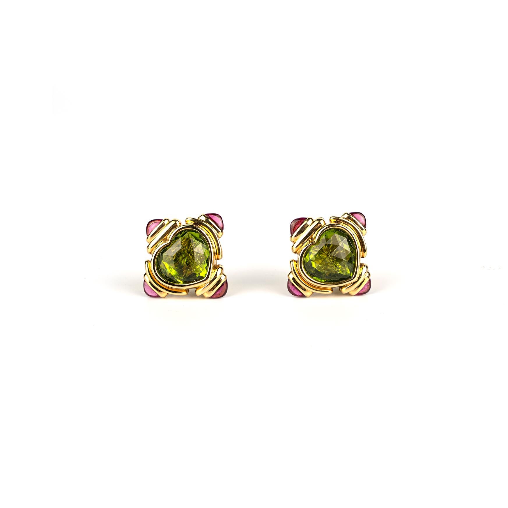 An elegant pair of vintage Bulgari 18k yellow gold earrings showcasing heart shaped peridots and cabochon pink tourmalines.  Made in Italy, circa 1980.