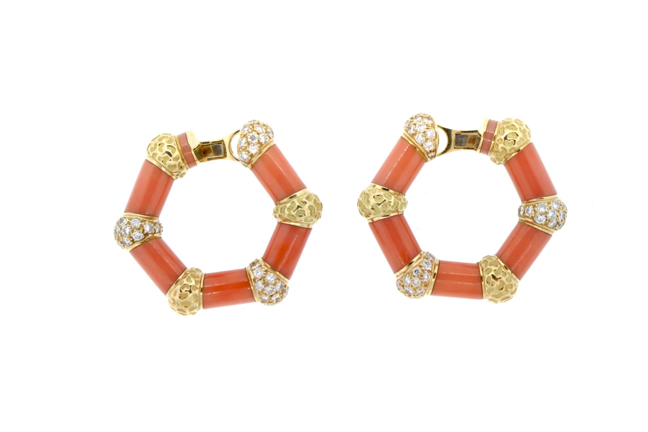 Sculptural vintage gold and diamond hoop earrings by Bulgari circa 1970.  These hoop earrings are worn close to the ear, and they have a subtle back to front design.  Six sections of coral and divided by hammered gold sections and diamond set