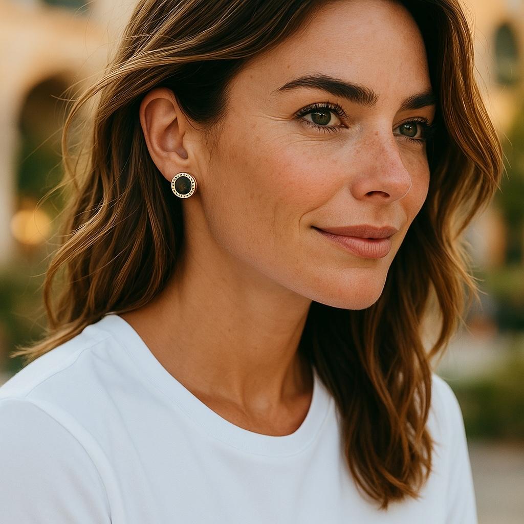 Capture the essence of Italian luxury with these striking Vintage Bulgari 18K Yellow Gold Black Onyx Circle Stud Earrings. Elegantly crafted in 18k yellow gold, each earring features a bold black onyx centerpiece, framed by the iconic BVLGARI logo