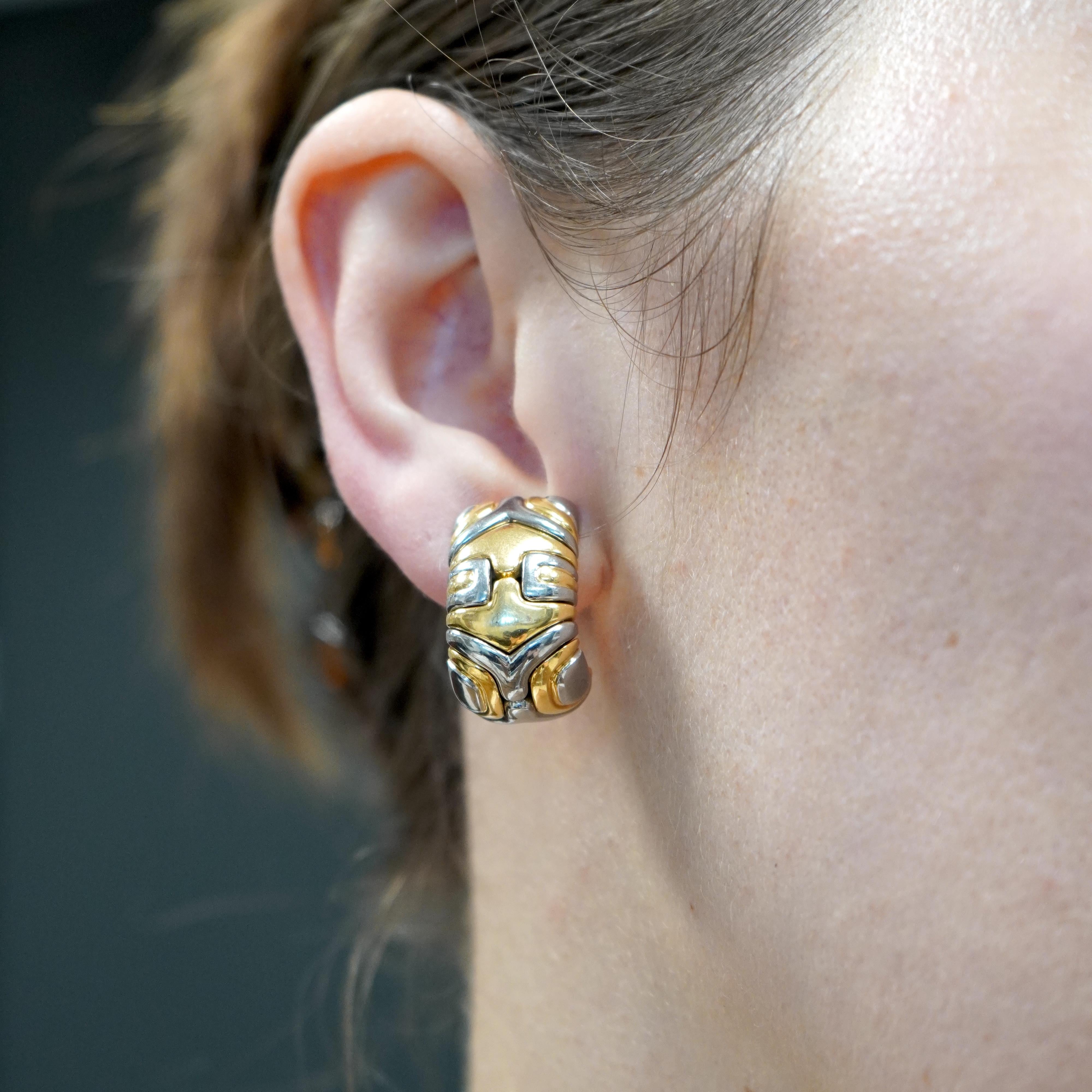 This pair of Bvlgari earrings from the 1980s is part of the brand's Alveare collection, known for its bold and structured designs. They are crafted from a combination of 18k gold and stainless steel, creating a striking contrast between the warm