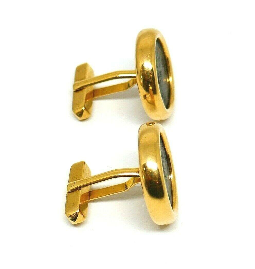 Vintage ancient Roman coin cufflinks by Bulgari. The bronze coin is framed in 18k yellow gold. Writing on the rib: 