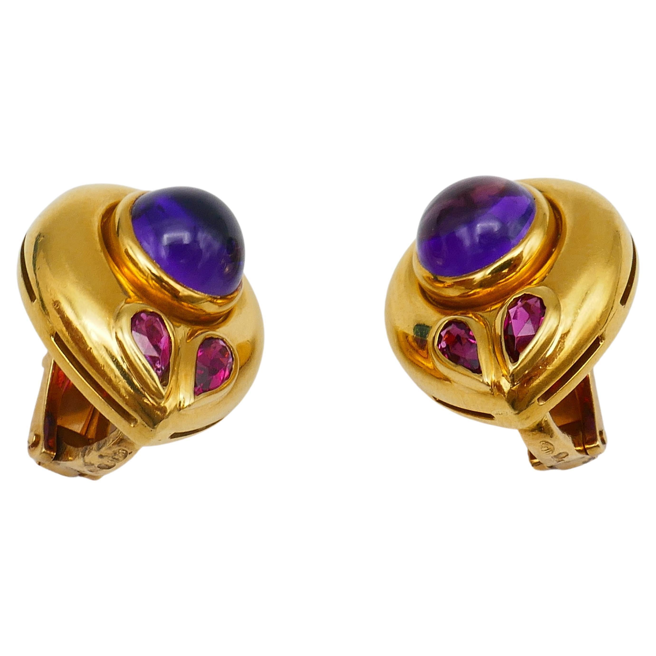 A cute pair of clip-on vintage Bulgari earrings. Made of 18k gold, featuring cabochon amethyst and pear shape tourmaline.
The amethyst's total carat weight is 4.41 carats, the tourmaline is 0.47 points.
The drop shape of the earrings looks very