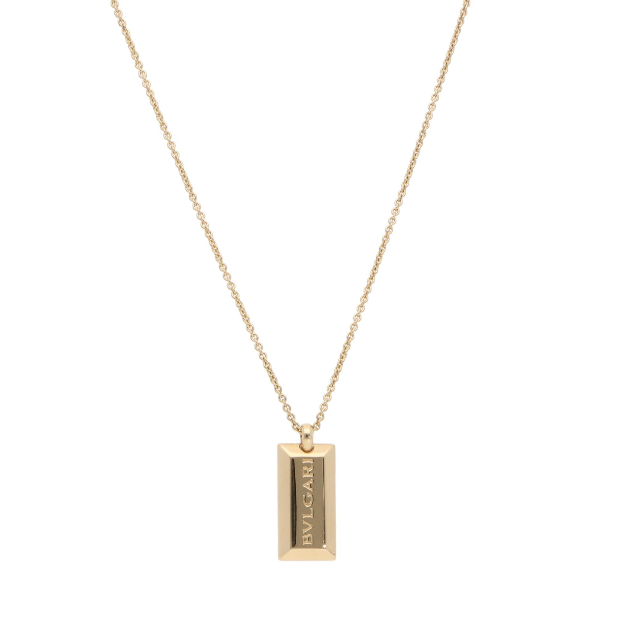A simple vintage Bulgari Ingot bar pendant necklace set in 18k yellow gold.

From the discontinued Ingot collection, the pendant is composed of a bar-shaped yellow gold piece engraved with the signature BVLGARI logo. The pendant hangs from a Bulgari
