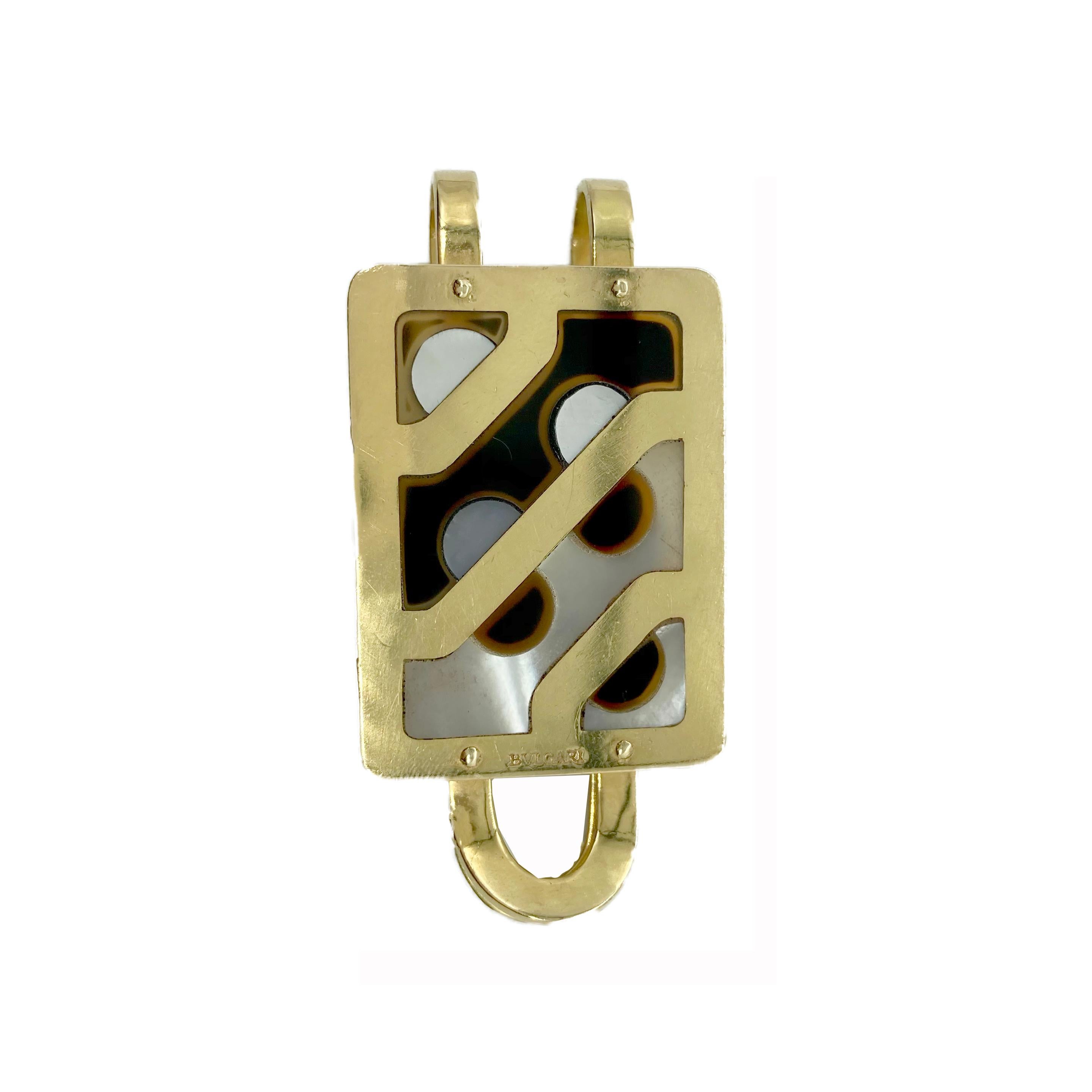 A sophisticated mother of pearl and onyx money clip by Bulgari. Made in Italy, 18 karat gold.