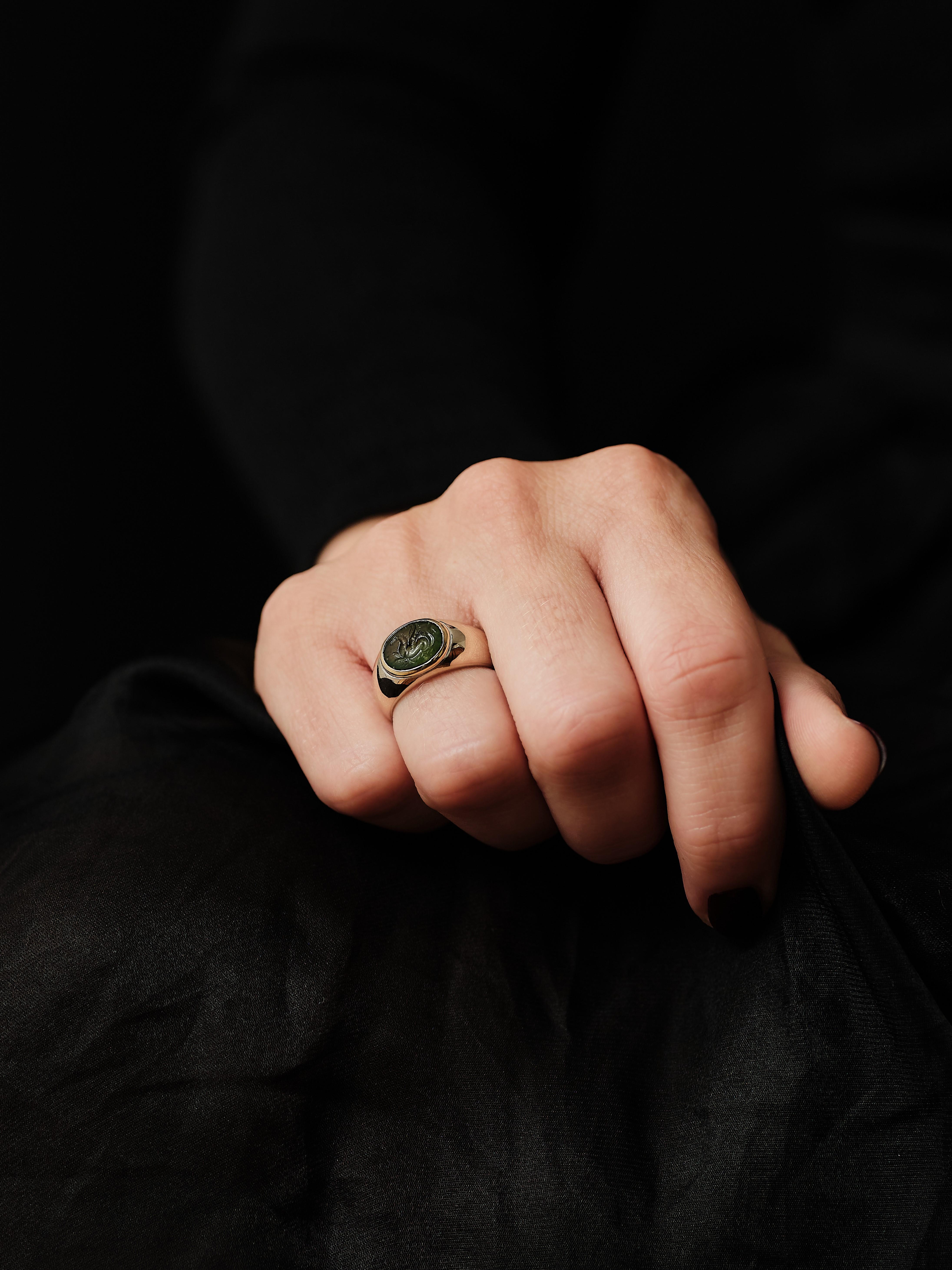 Vintage Bulgari ring with nephrite Intaglio of Pegasus 1st century BCE

18 karat white gold ring with a yellow gold bezel setting. Made circa 1970-80s

The oval translucent green nephrite with a carving of Pegasus. Born from the blood of the Gorgon