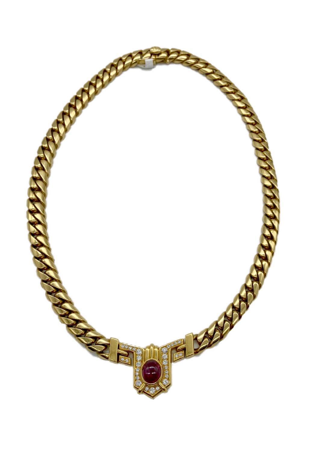 A chic necklace by Bulgari featuring a natural ruby cabochon surrounded by diamonds, suspended from an 18 karat yellow gold chain. Made in Italy, circa 1970s.