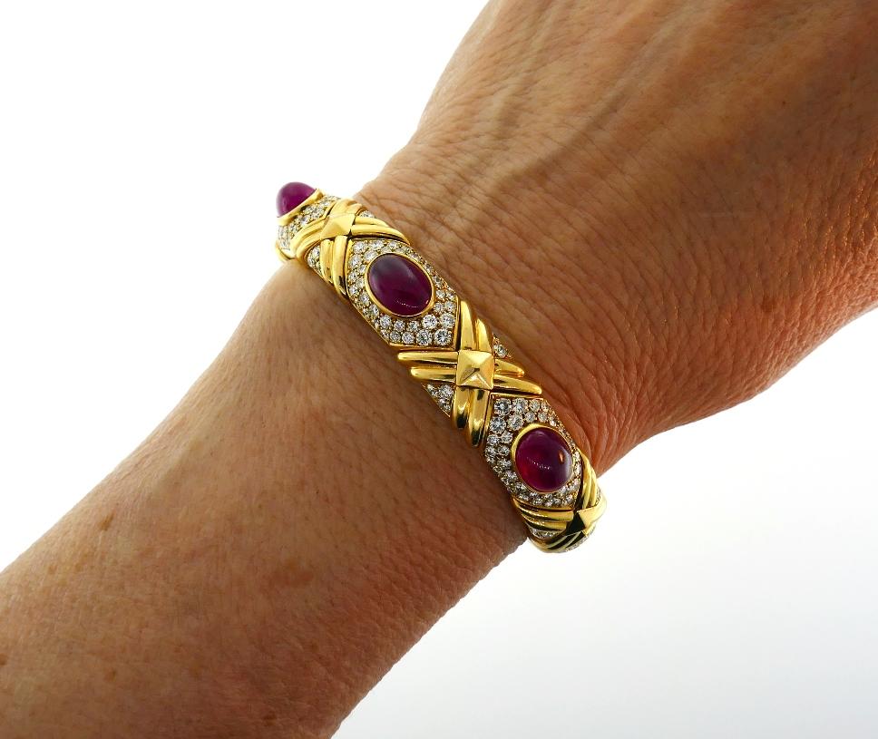 Iconic Bulgari bangle bracelet created in Italy in the 1980s. Chic and wearable, the bracelet is a great addition to your jewelry collection. 
Made of 18 karat yellow gold, the bracelet features three oval cabochon Burmese rubies accented with round