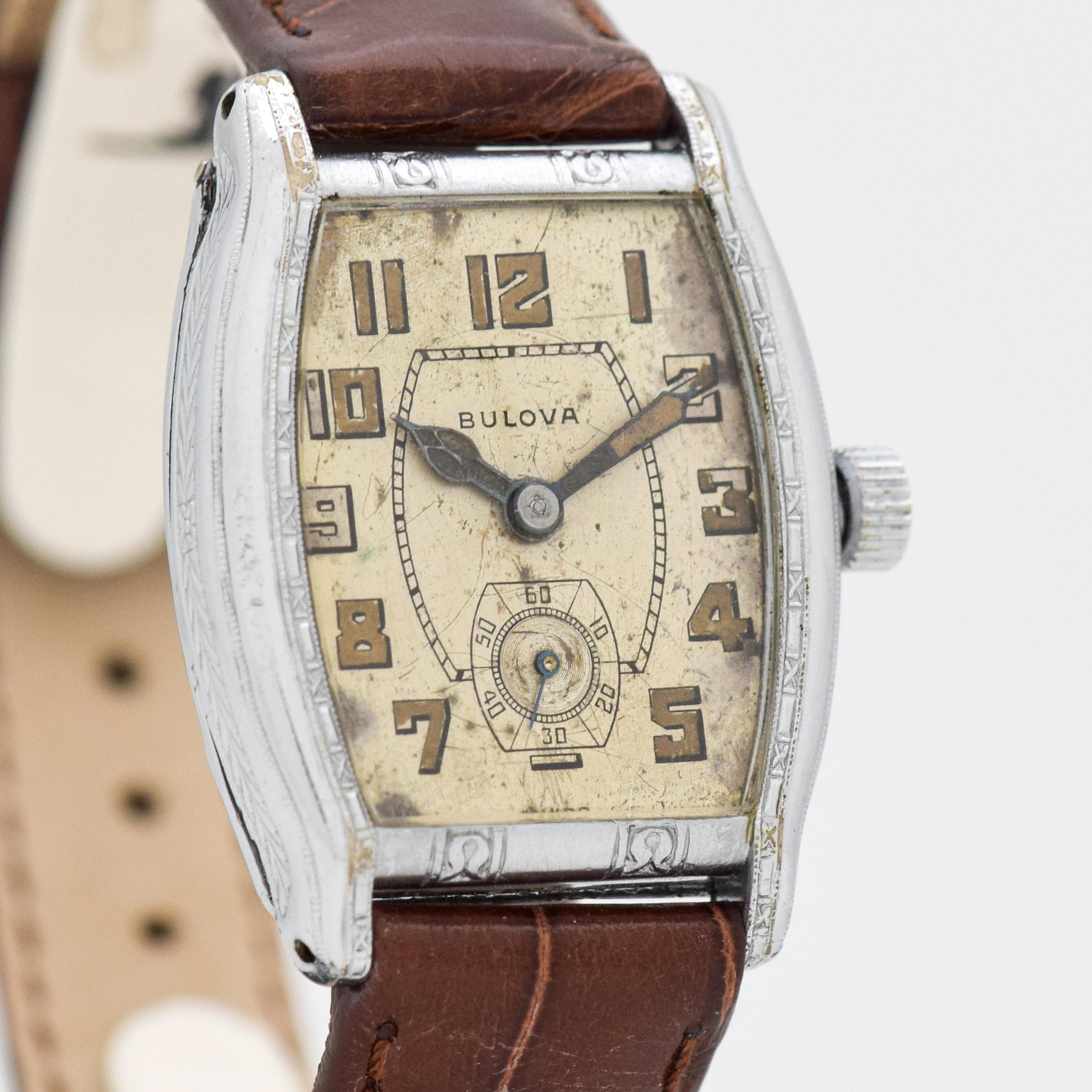 1929 Vintage Bulova 14k White Gold Filled Art Deco Case watch with Original Patina Silver Dial with Patina Luminous Arabic Numbers. Case size, 26mm x 35mm lug to lug (1.02 in. x 1.38 in.) - Powered by a 17-jewel, manual caliber movement. Tripe