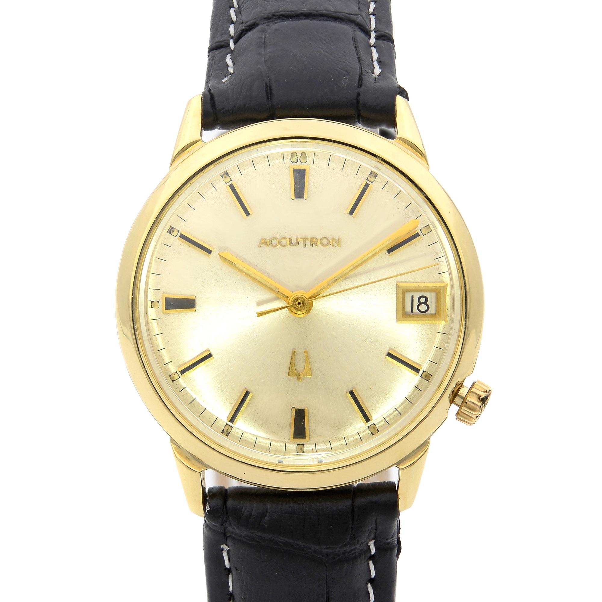 This pre-owned Bulova  NA is a beautiful men's timepiece that is powered by quartz (battery) movement which is cased in a yellow gold case. It has a round shape face, date indicator dial, and has hand sticks style markers. It is completed with a