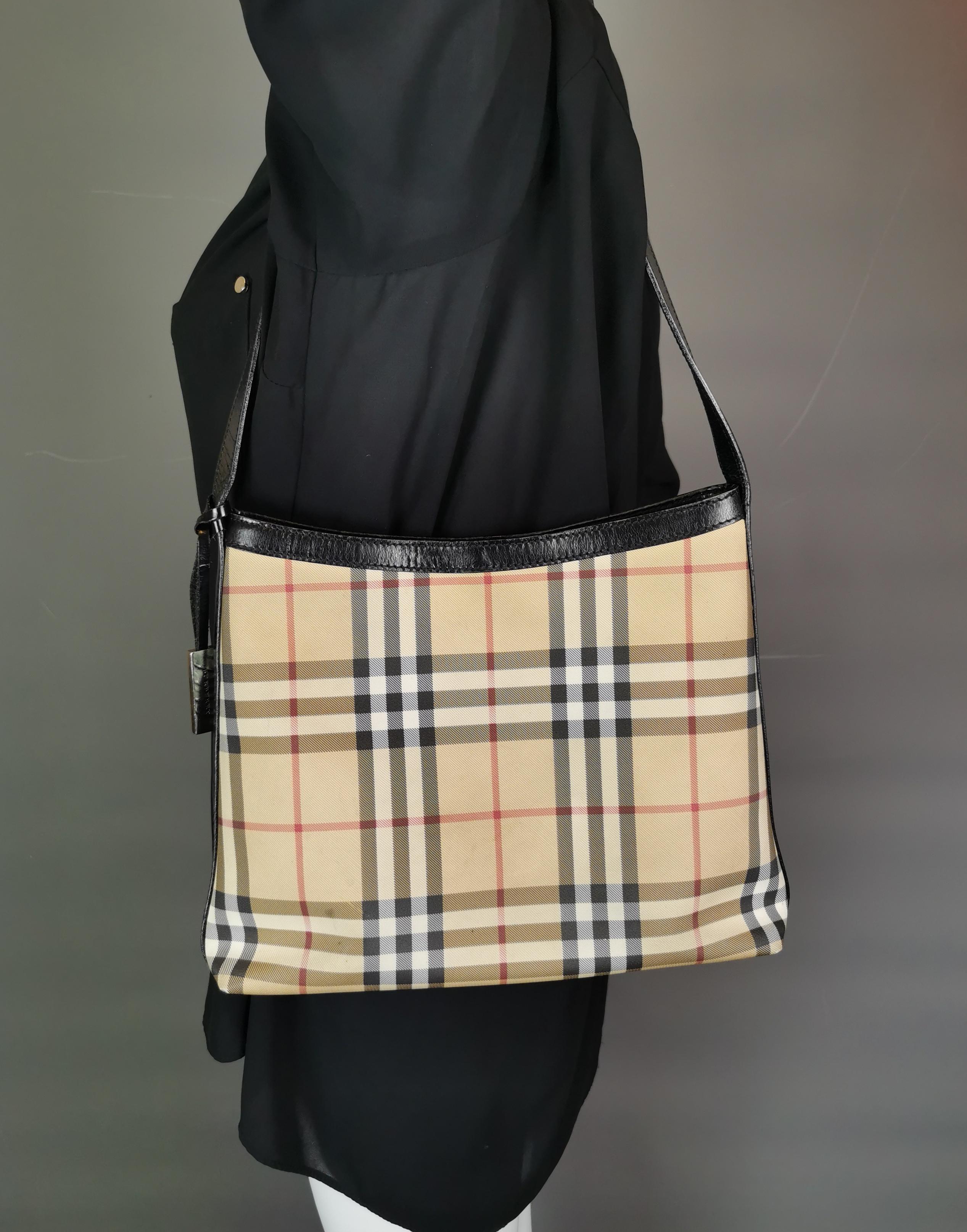 An ever stylish vintage Burberry tote bag. 

Classic Nova check in a lightly coated canvas in Burberry signature colours. 

It has a black leather handle and silver tone hardware branded. 

Inside the purse there is the Burberry branding on a