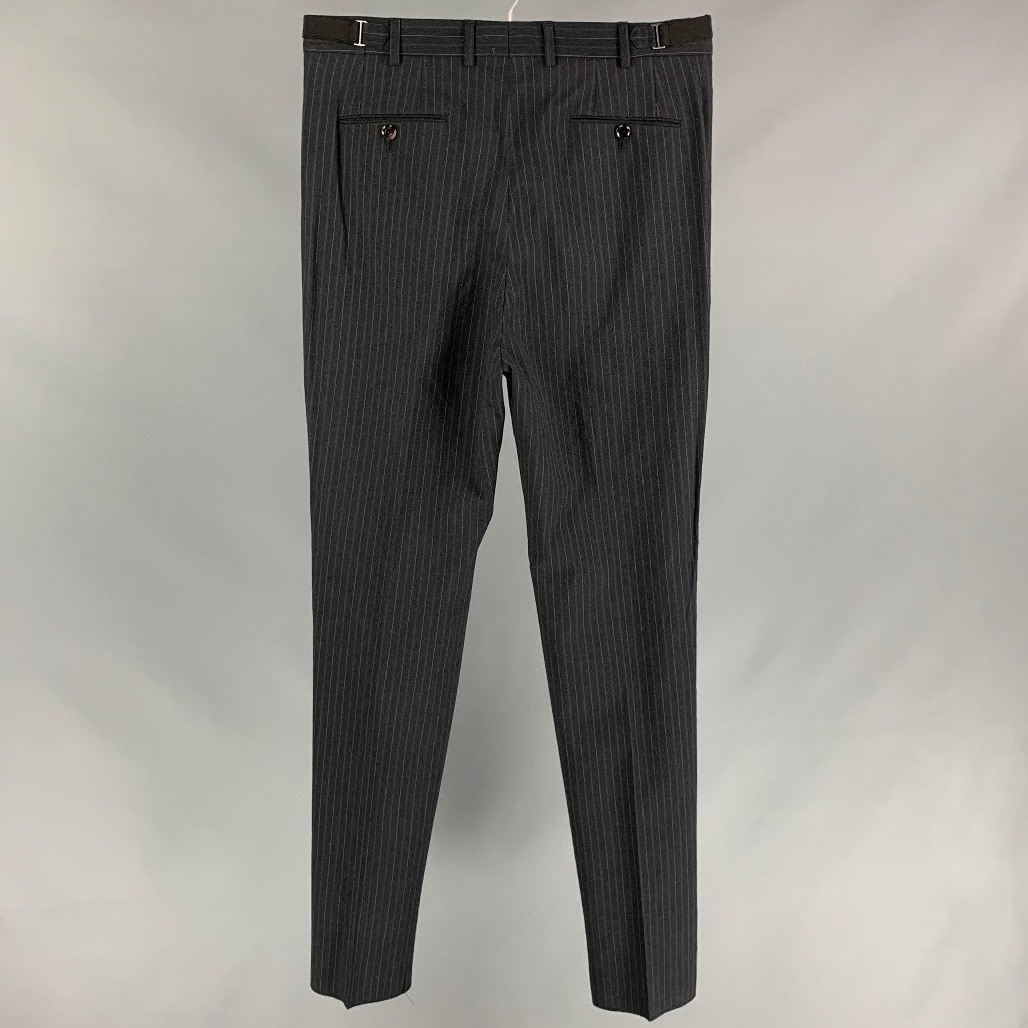 Vintage BURBERRY PRORSUM dress pants comes in a charcoal & grey chalk stripe wool featuring a pleated style, slim fit, adjustable side tabs, front tab, and a zip fly closure. Made in Italy.
Very Good
Pre-Owned Condition. 

Marked:   No size marked. 