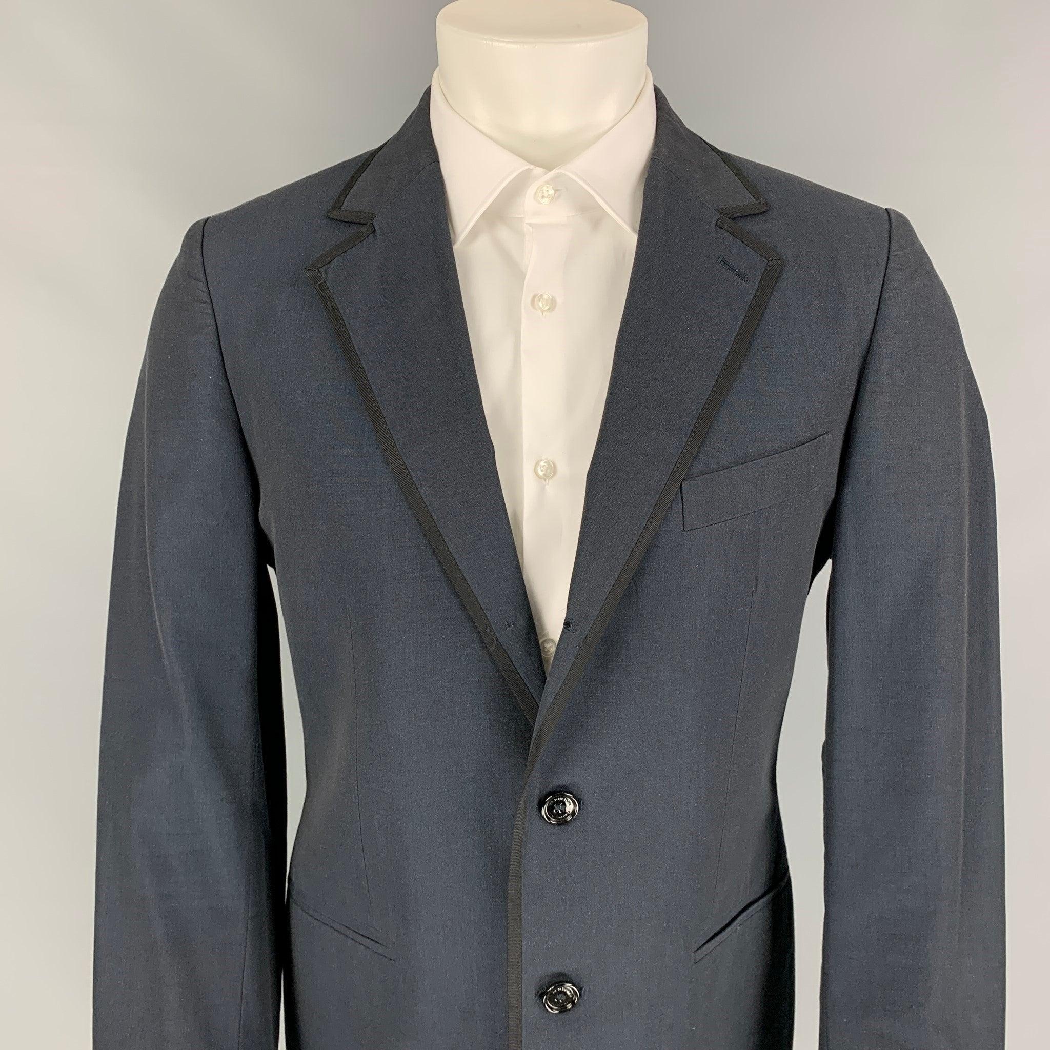 BURBERRY PRORSUM sport coat comes in a navy cotton / mohair with a full liner featuring a notch lapel, black ribbon trim, single back vent, and a double button closure. Made in Italy.
Very Good
Pre-Owned Condition. 

Marked:   52 

Measurements: 
