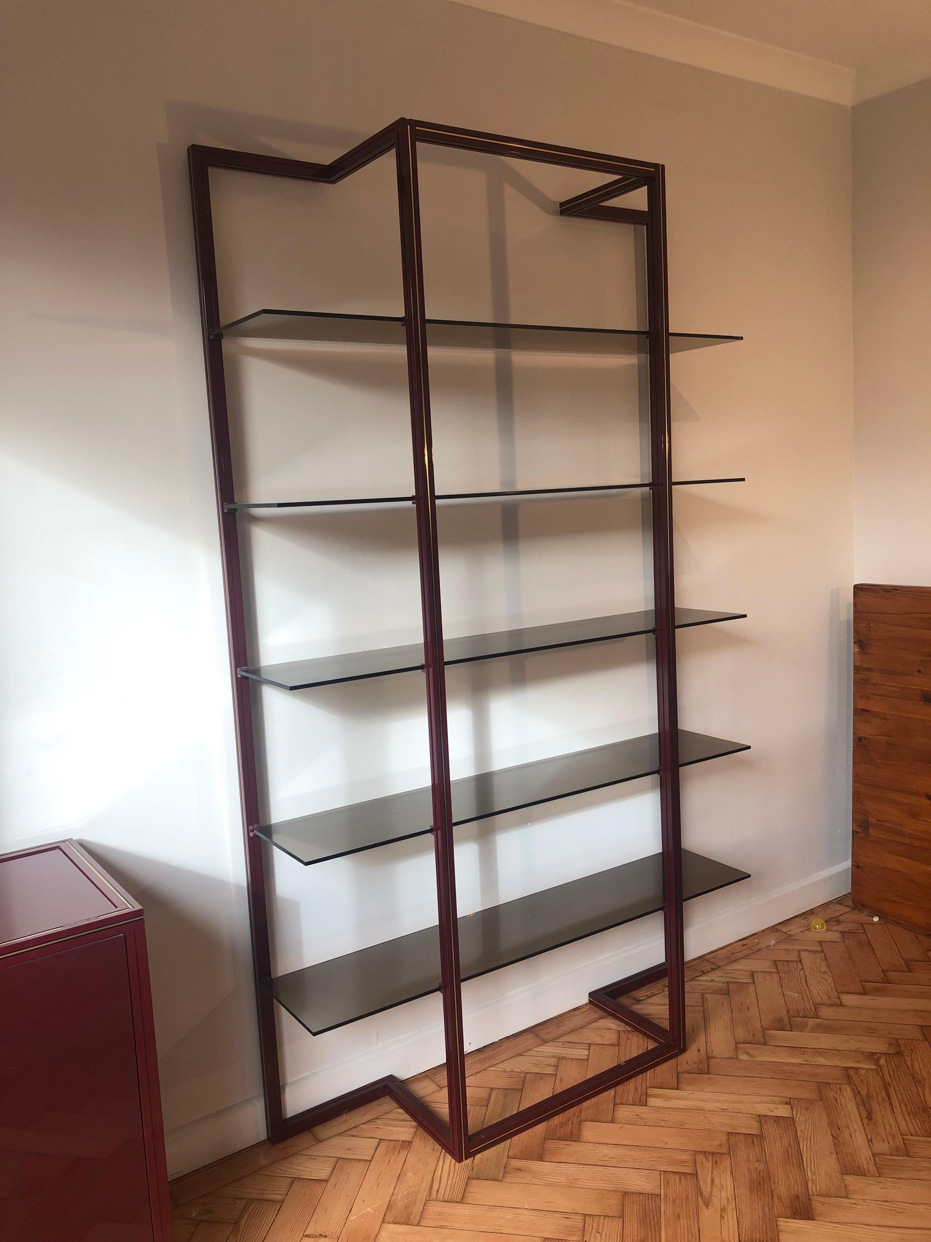 Pierre Vandel tall étagère with smoked glass shelves and aluminum frame. Overall good original condition with the occasional wear. Couple glass chips on the shelves and some scratches.
  