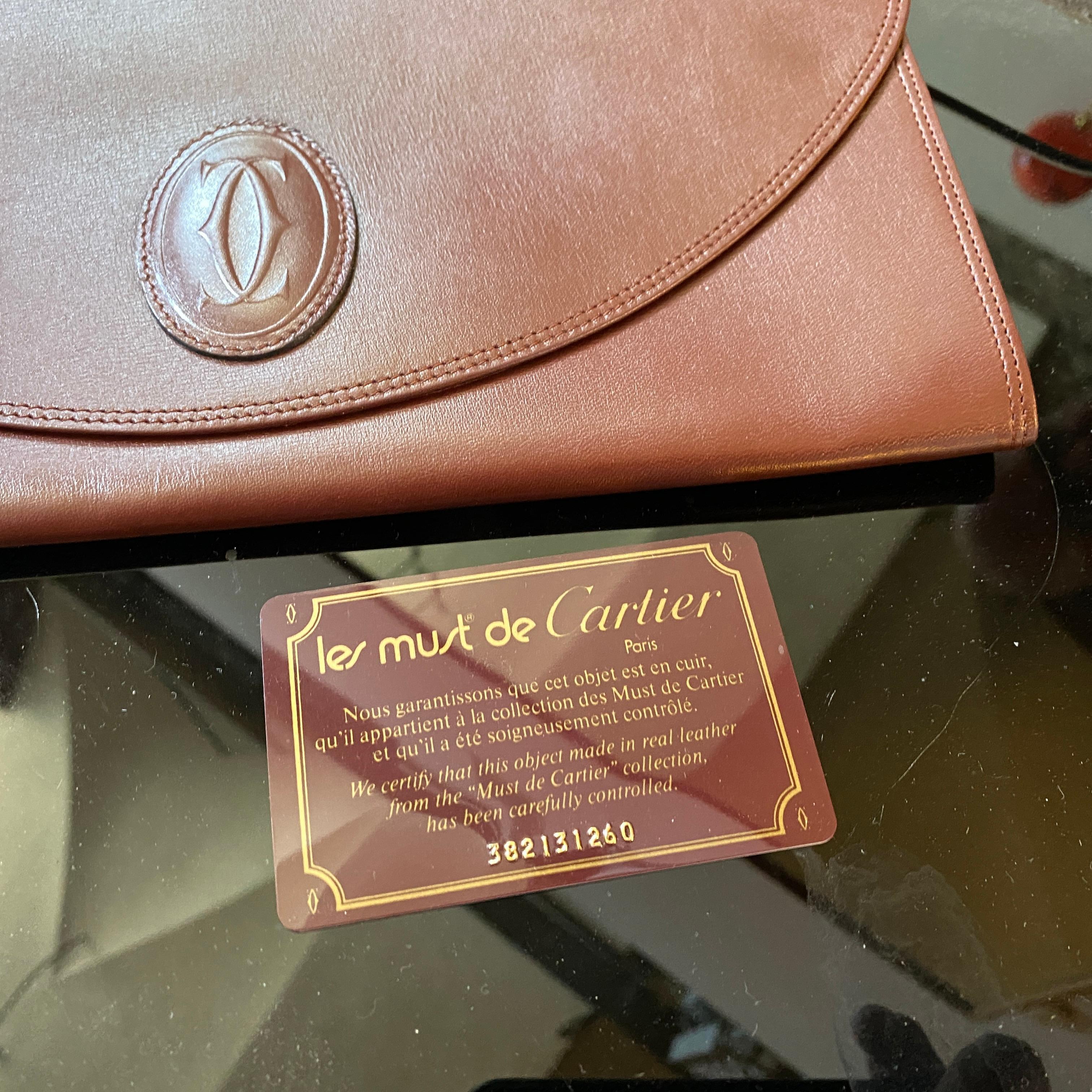 A perfect condition Cartier leather clutch bag, mini document purse with Cartier logo motif. Rare 