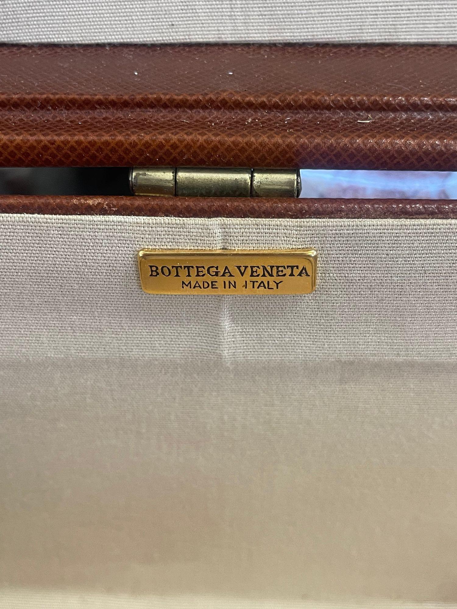 A vintage Bottega Veneta embossed leather suitcase in an alluring dark burgundy tone; having brass fittings and reinforced corners. It also includes a combination lock. Made in Italy, c. 1980's.
Dimensions:
19.5