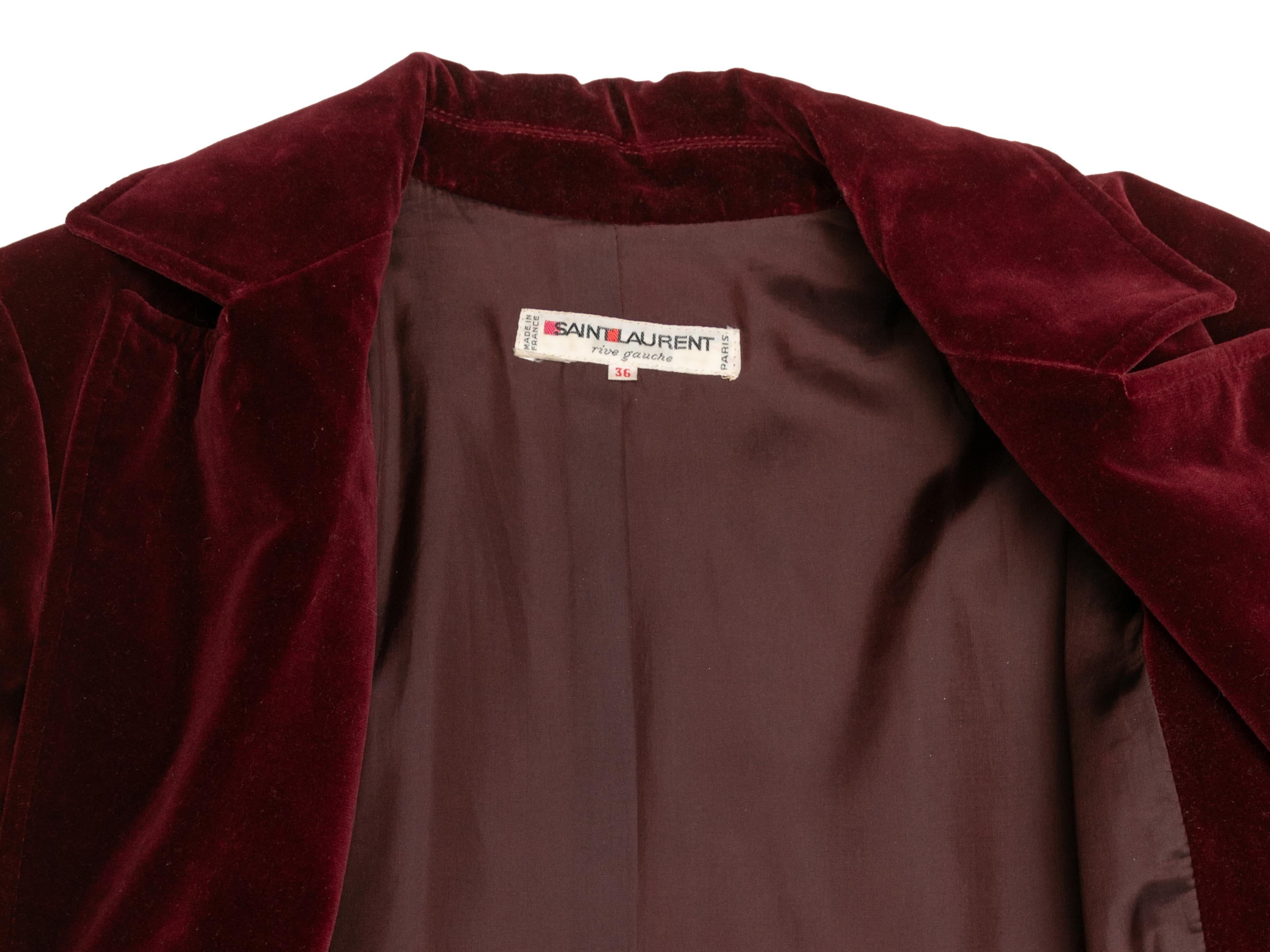  Vintage burgundy velvet coat by Saint Laurent Rive Gauche. Notched lapel. Three pockets. Button closures at center front. 37