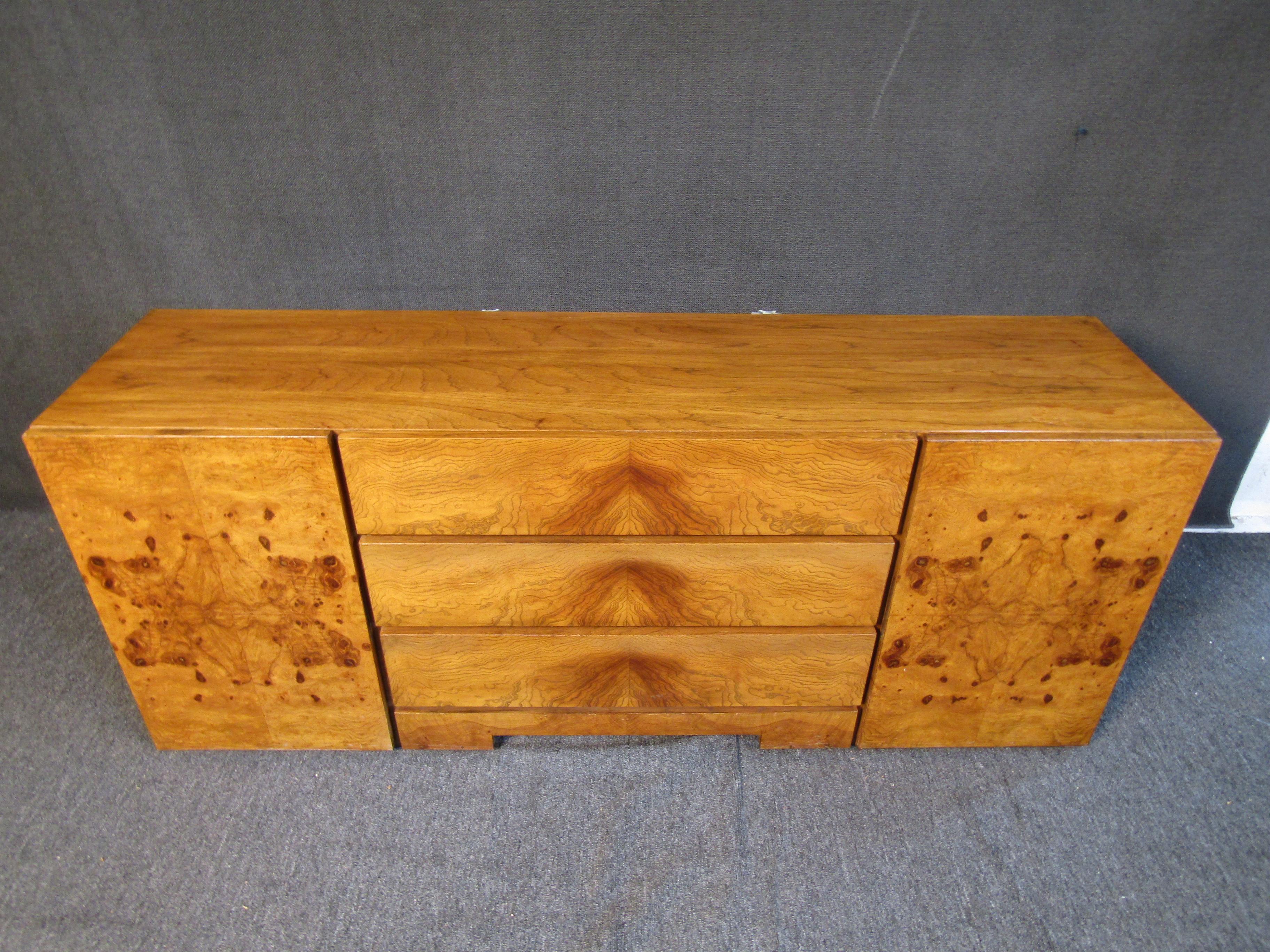 This vintage credenza designed in the style of Milo Baughman shows off a beautiful burl wood finish with nine separate drawers for ample storage. Please confirm item location with seller (NY/NJ).