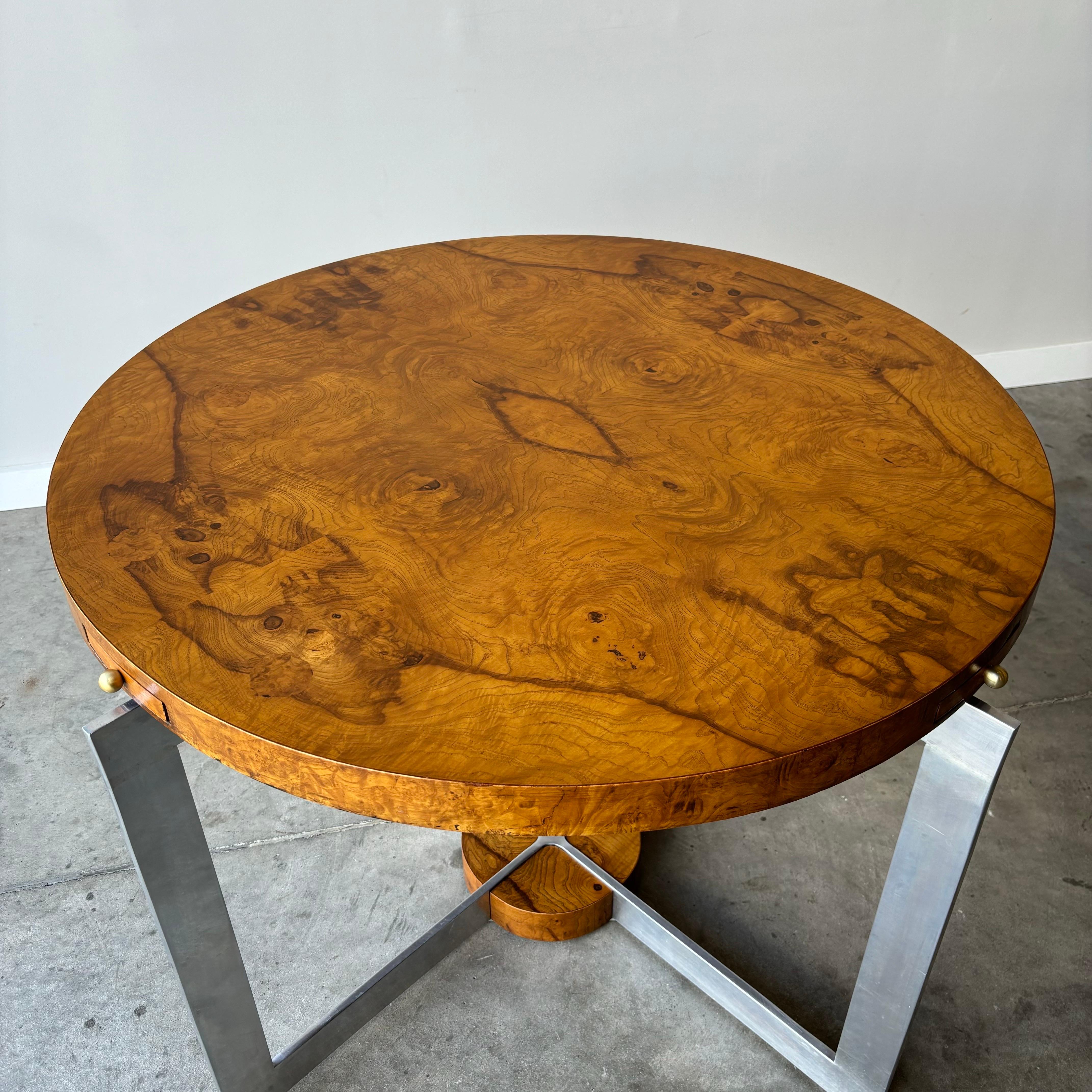 Mid century burl game table with drink drawers, brass pulls and aluminum base.  A striking and unique vintage piece in very good condition.  