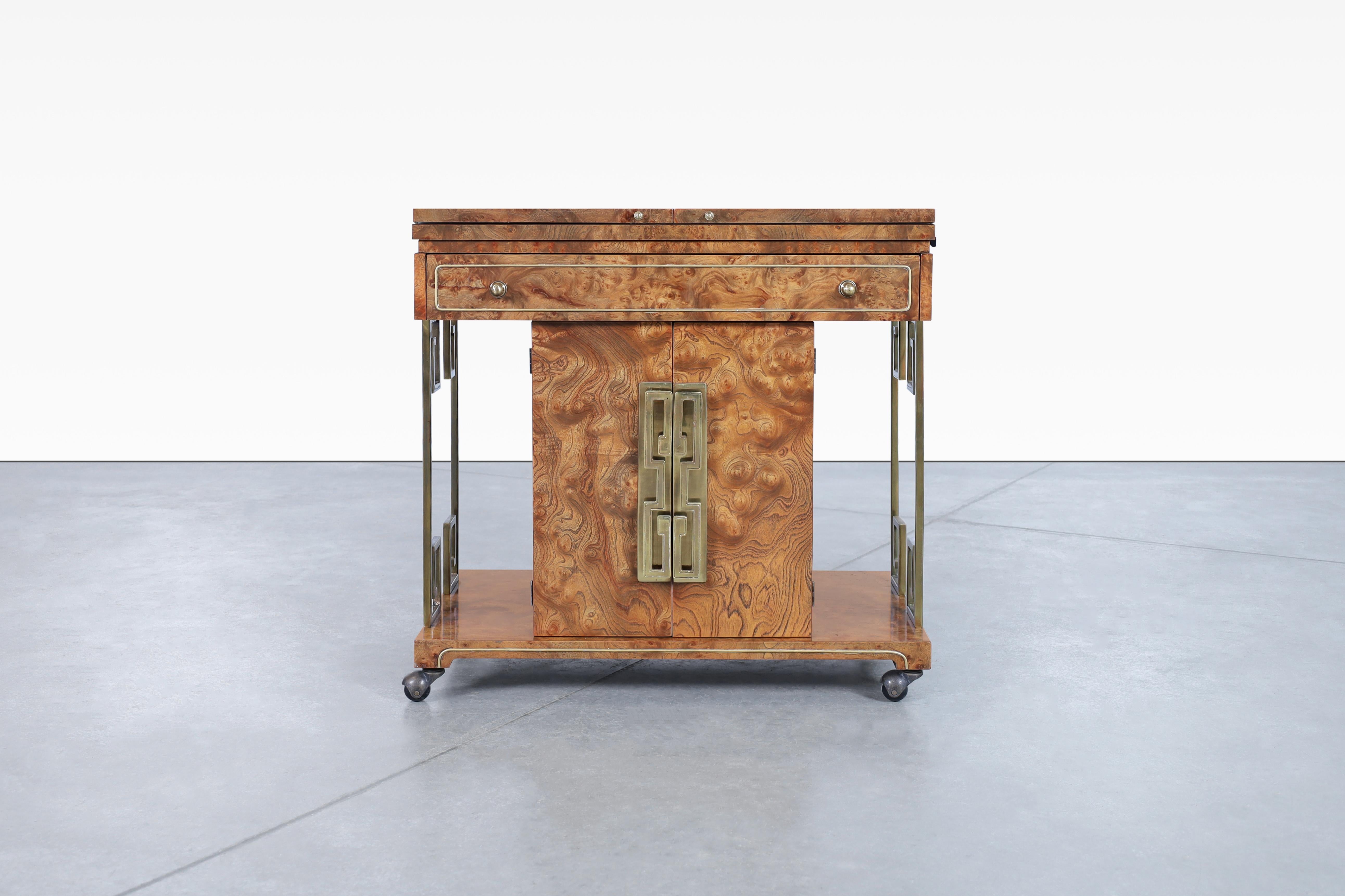 Stunning vintage burl wood and brass bar produced in the United States, circa 1970s. Created by the renowned designer Bernhard Rohne and manufactured by Mastercraft, this bar cart exudes the modernism movement. Crafted with attention to detail, it