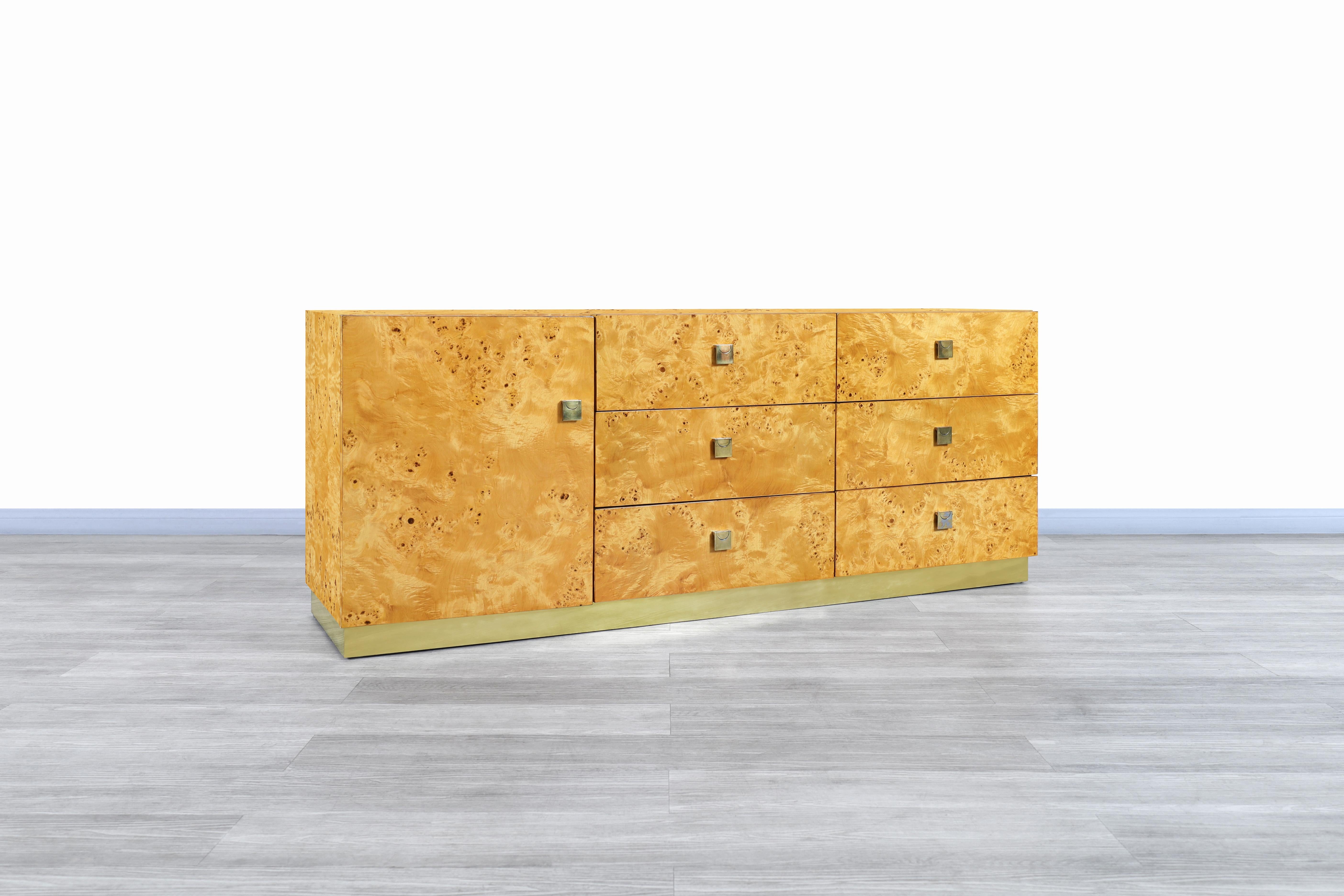 Gorgeous vintage burl wood and brass credenza manufactured by Founders in the United States, circa 1980s. This credenza is inspired by the iconic designs of the famous designer Milo Baughman. This collection was characterized by having fine